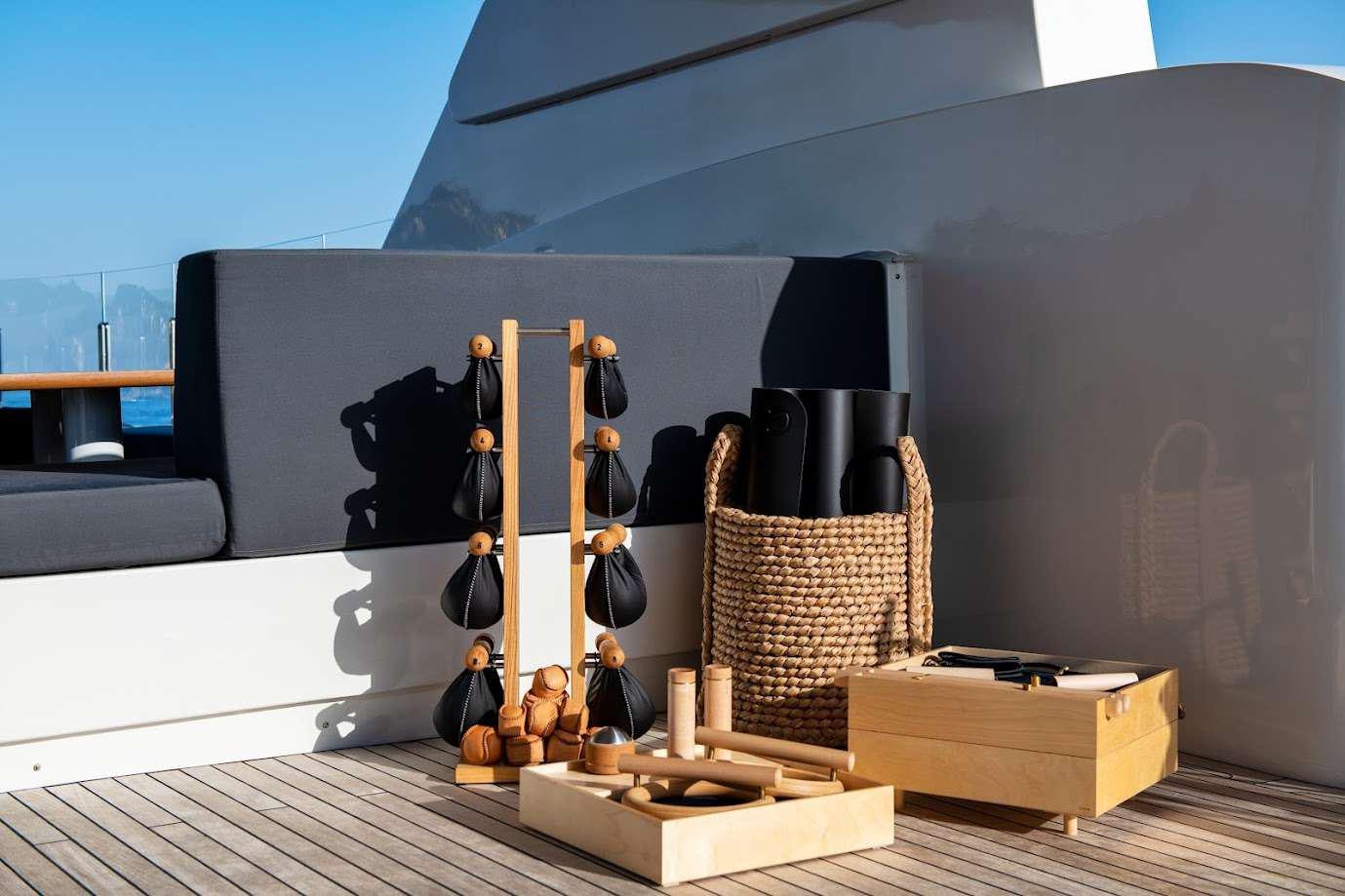 a sculpture of a guitar on a stand in front of a wall aboard ZIA Yacht for Charter