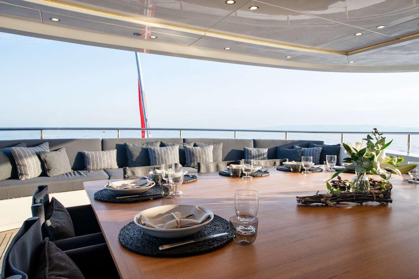 a large room with a table and chairs aboard ZIA Yacht for Charter