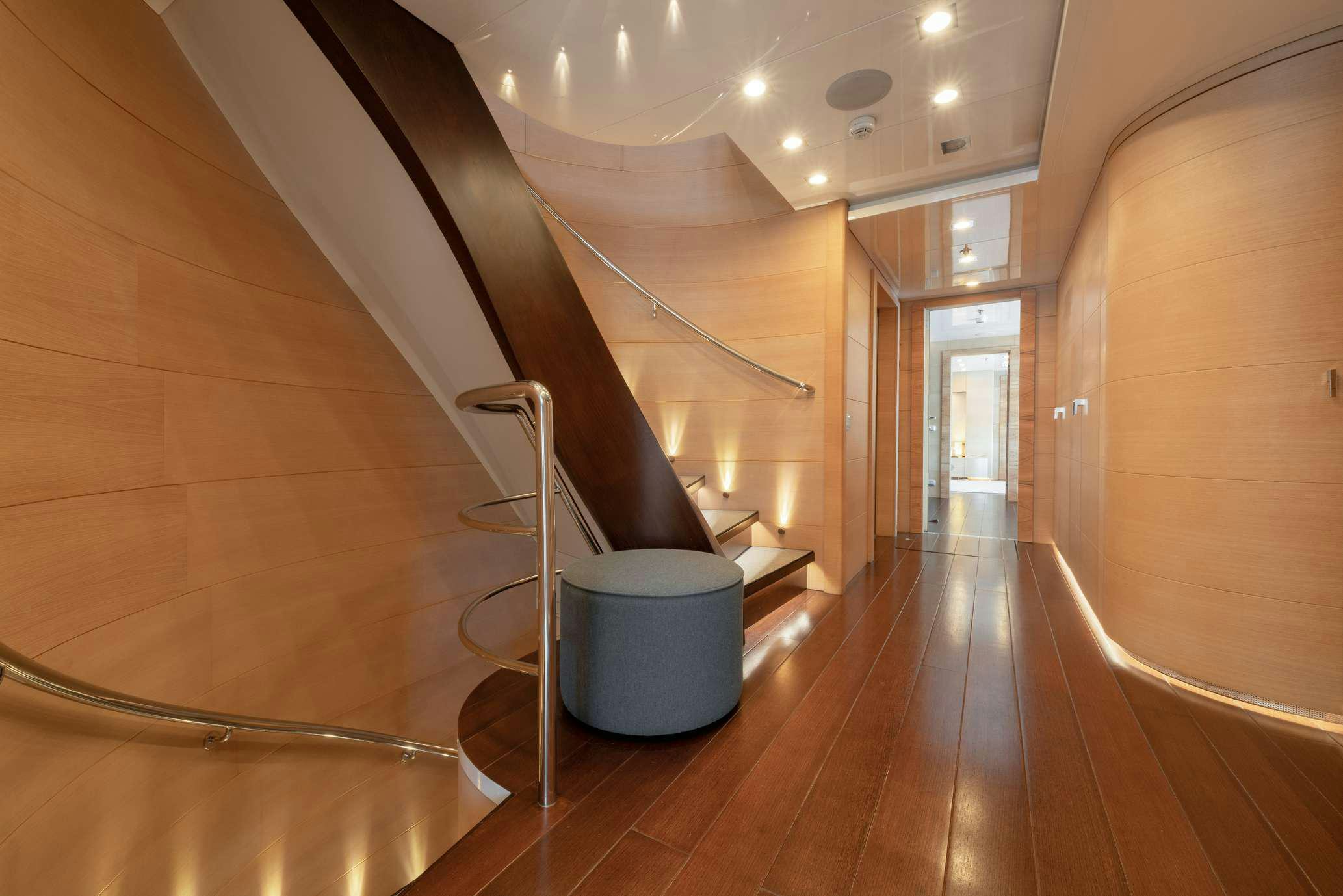 a room with a wood floor and a staircase aboard ZIA Yacht for Charter