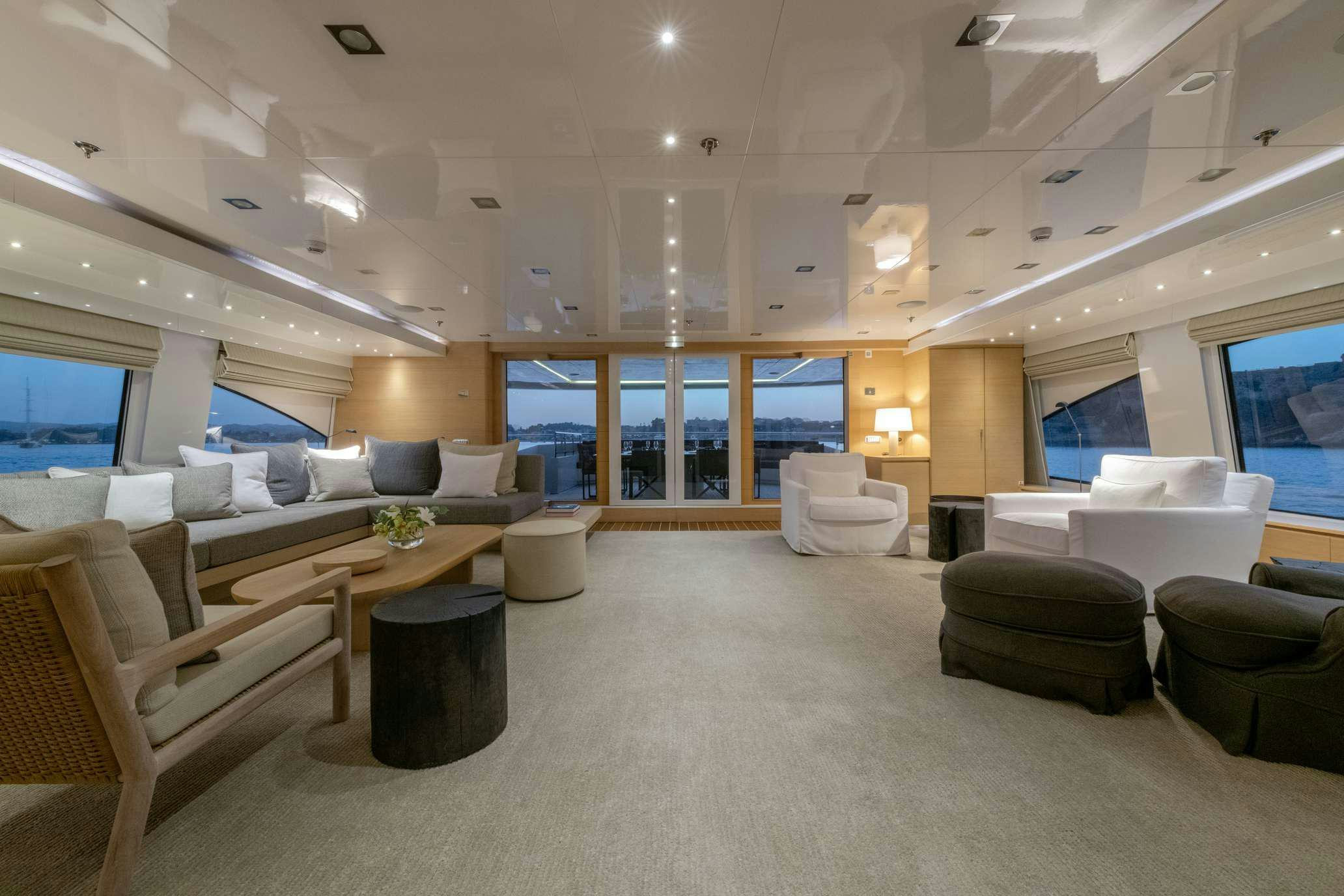 a room with couches and tables aboard ZIA Yacht for Charter