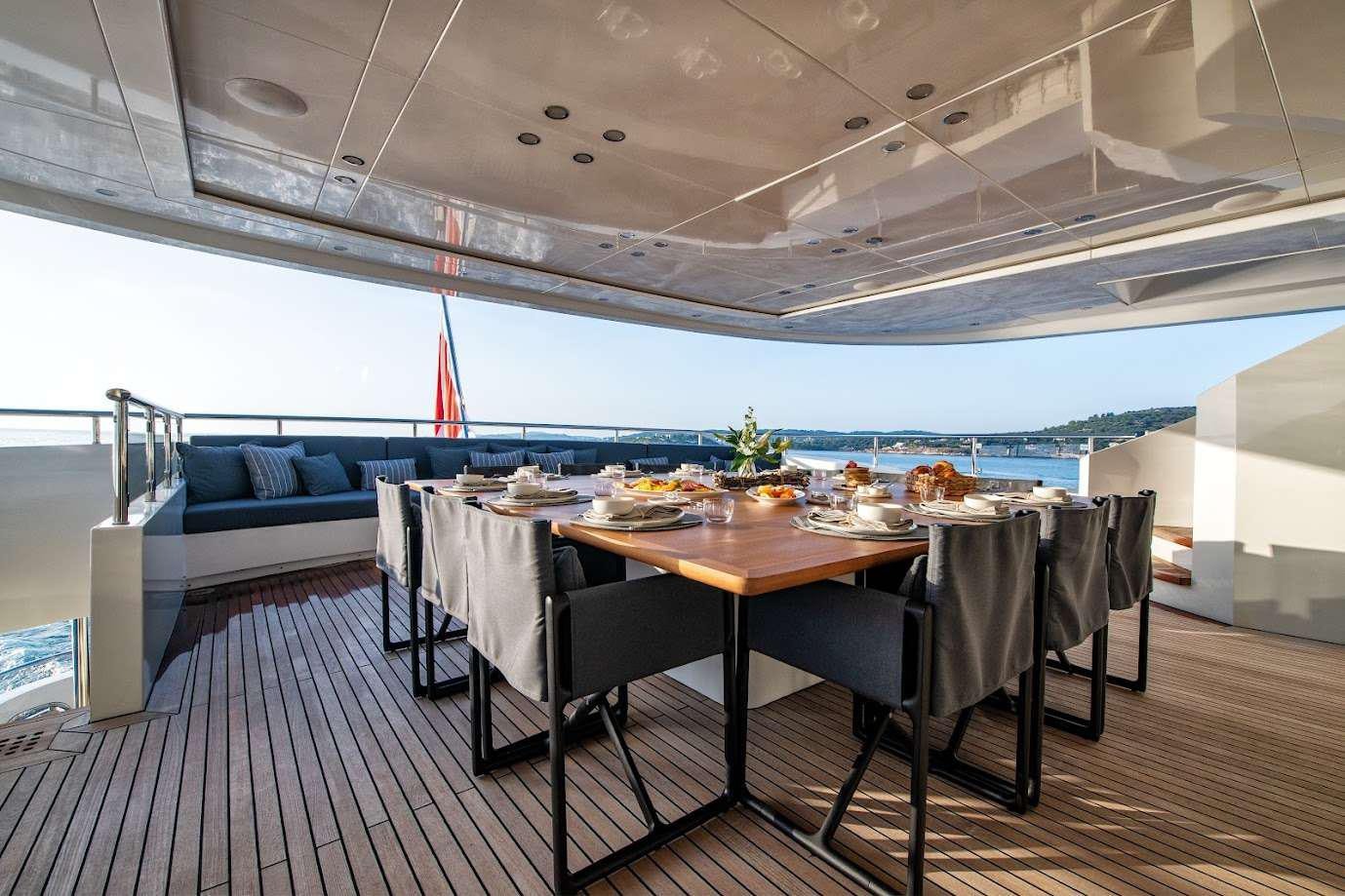 a room with a table and chairs aboard ZIA Yacht for Charter