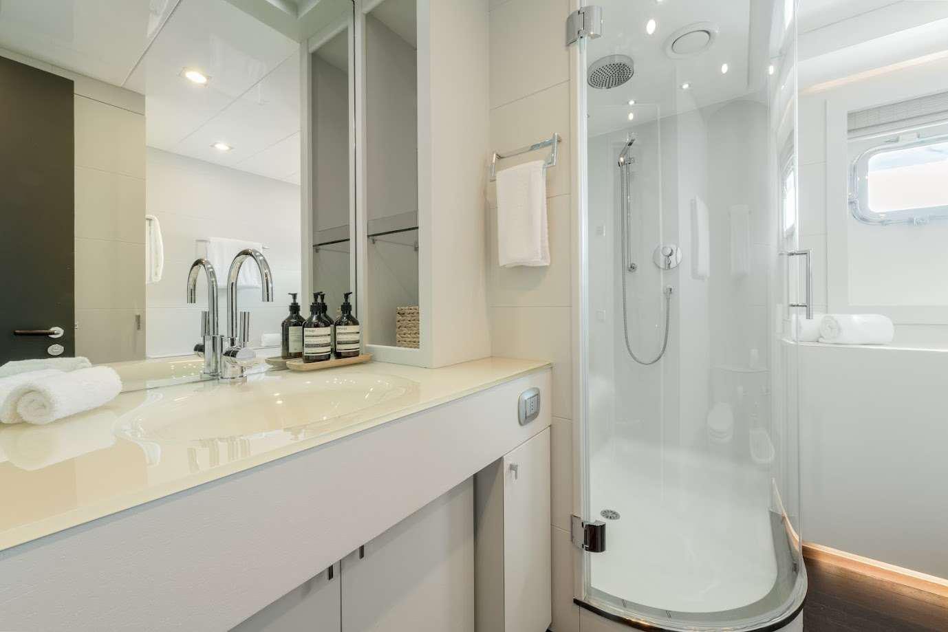 a bathroom with a shower and sink aboard ZIA Yacht for Charter