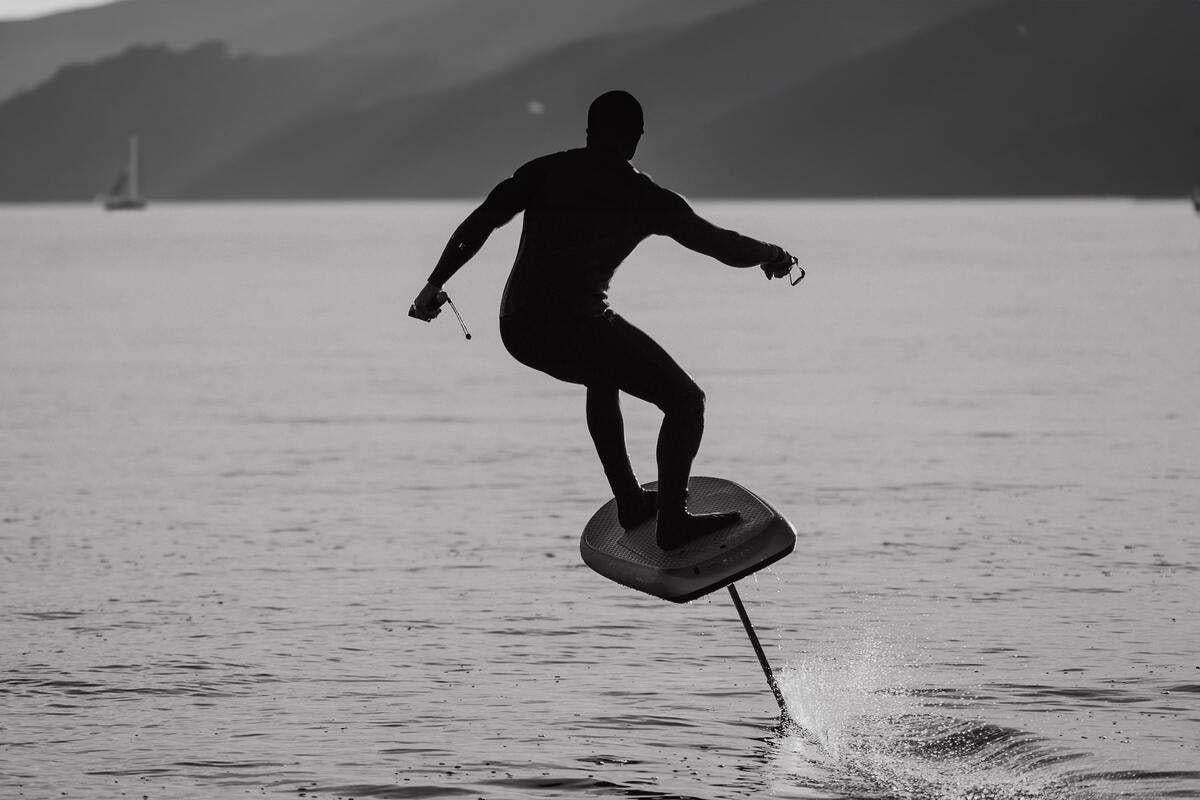 a man is water skiing aboard SERENISSIMA III Yacht for Charter