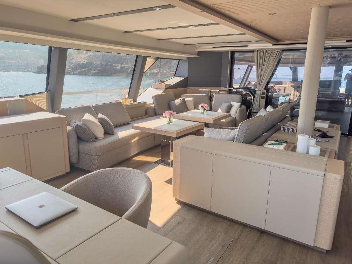 a living room with a large window aboard SERENISSIMA III Yacht for Charter