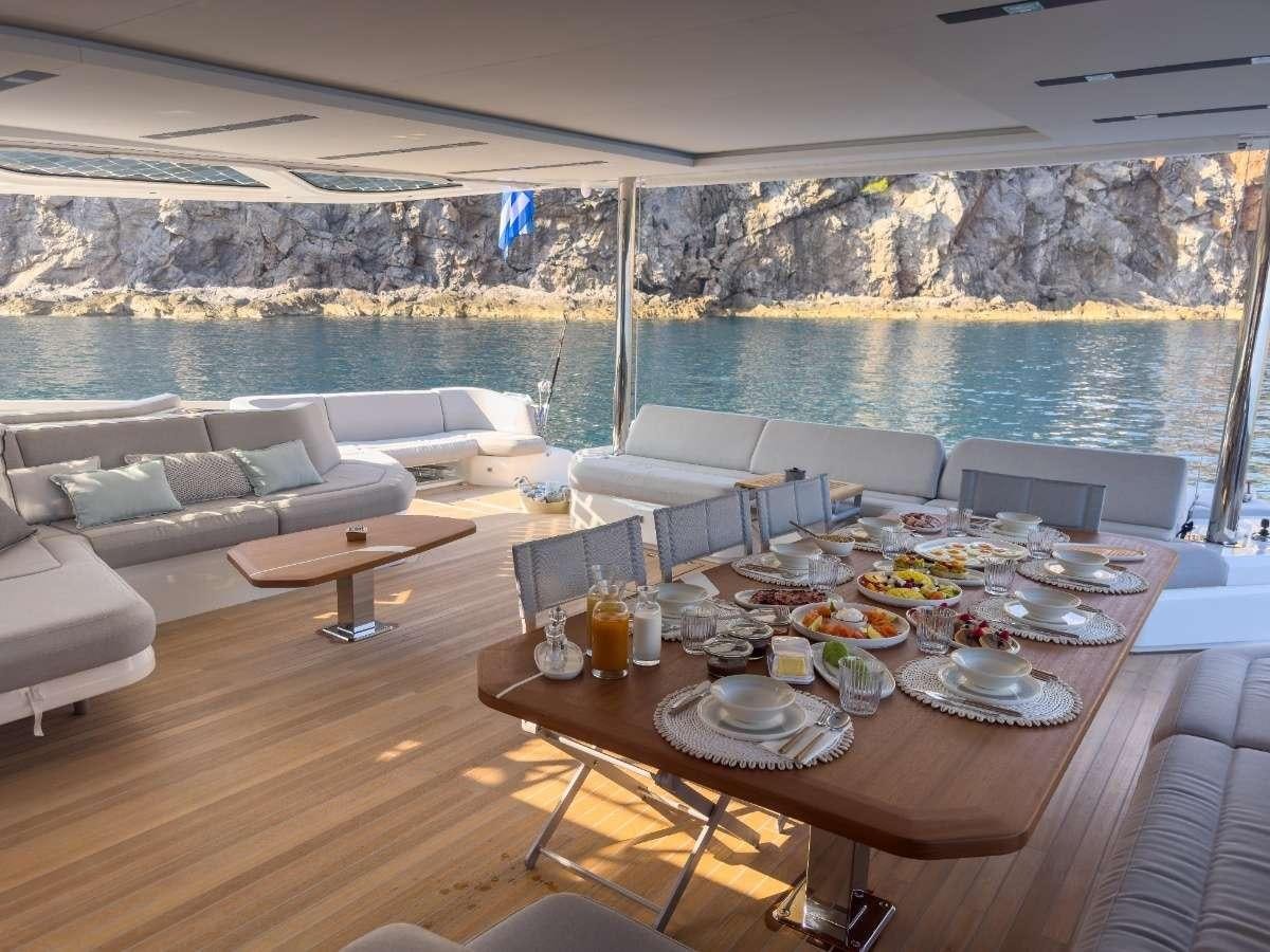 a table with plates and food on it aboard SERENISSIMA III Yacht for Charter