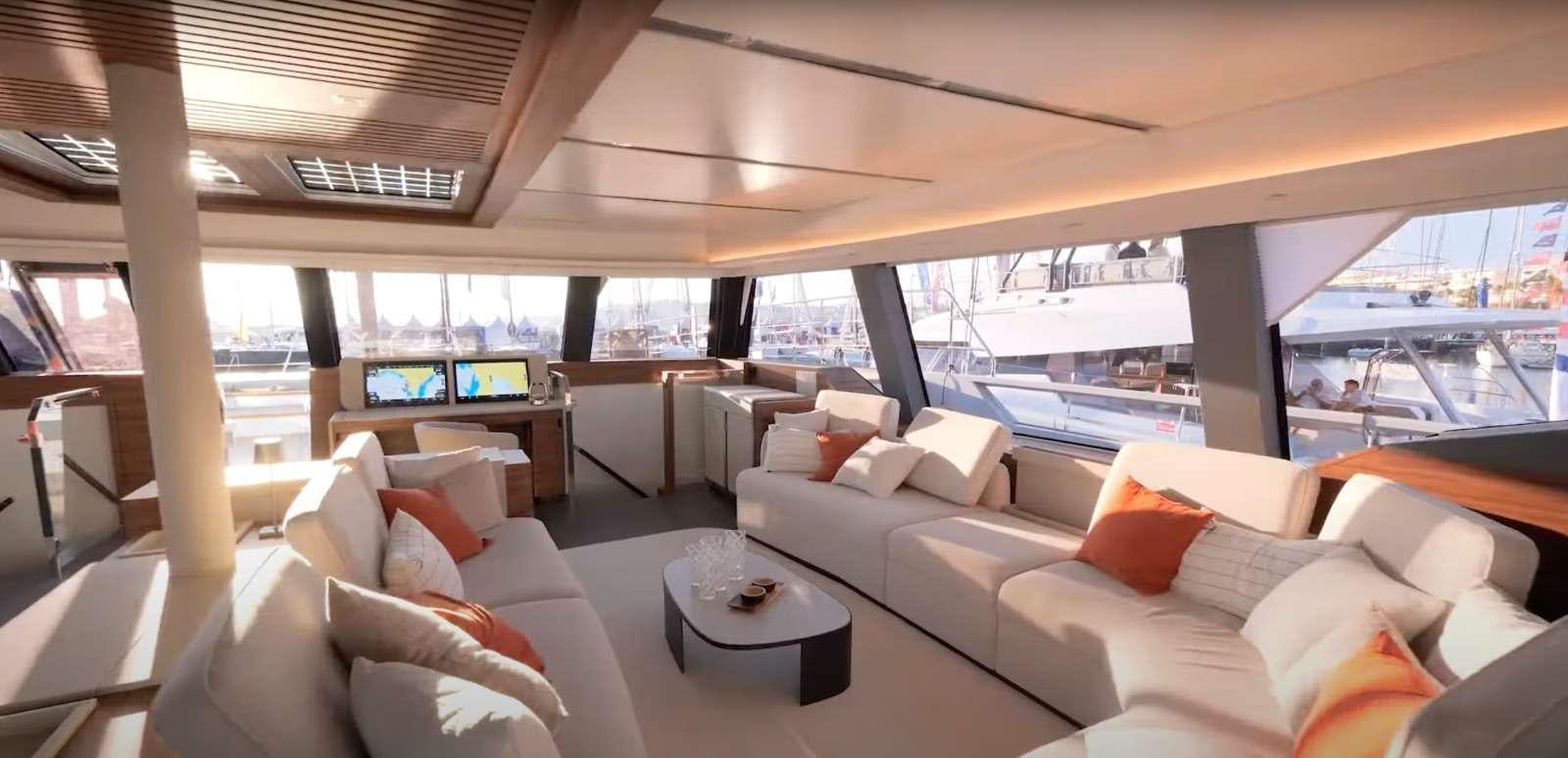 a living room with a large window aboard SERENISSIMA III Yacht for Charter