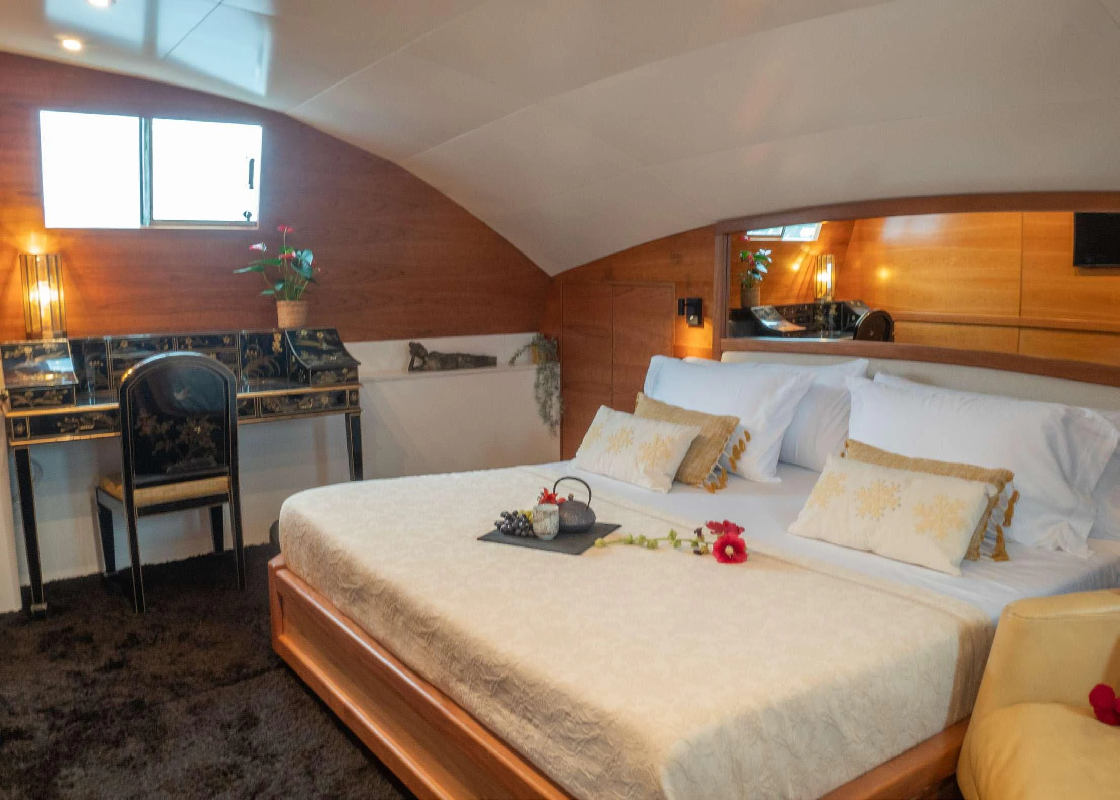 a bed with white sheets and pillows aboard BLUE GOLD Yacht for Charter