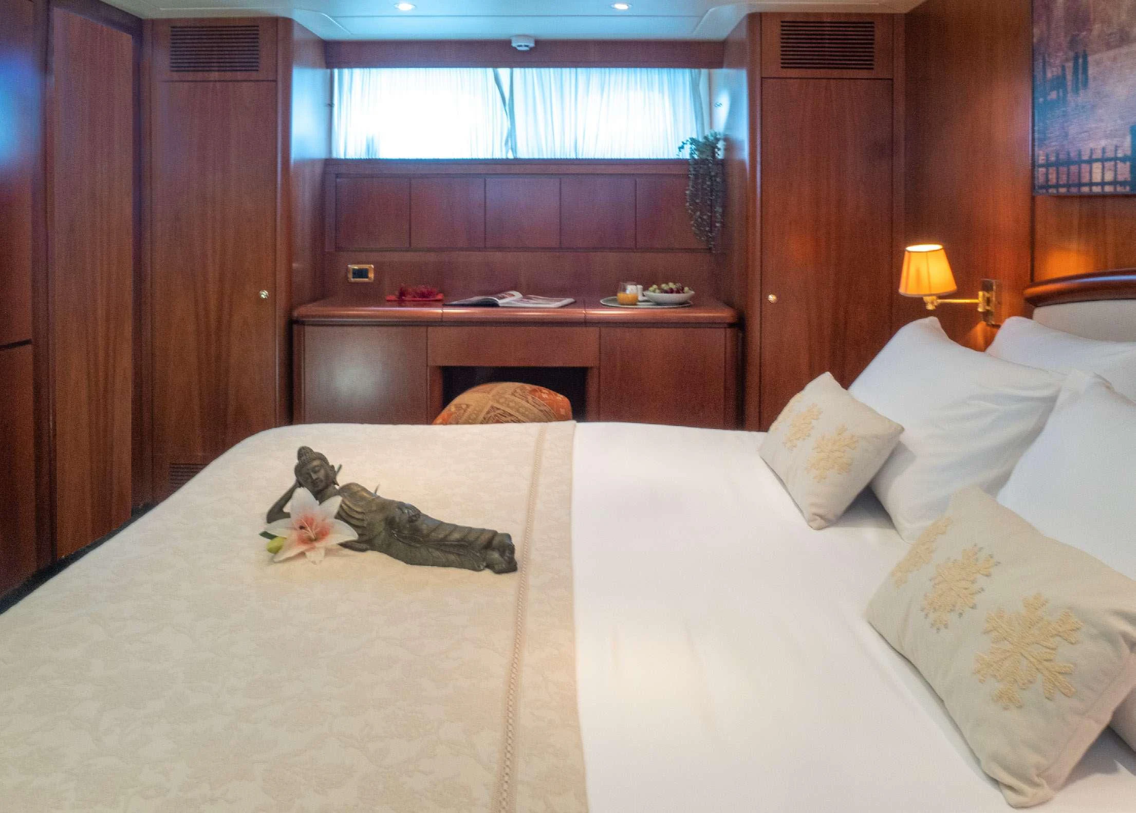 a cat lying on a bed aboard BLUE GOLD Yacht for Charter