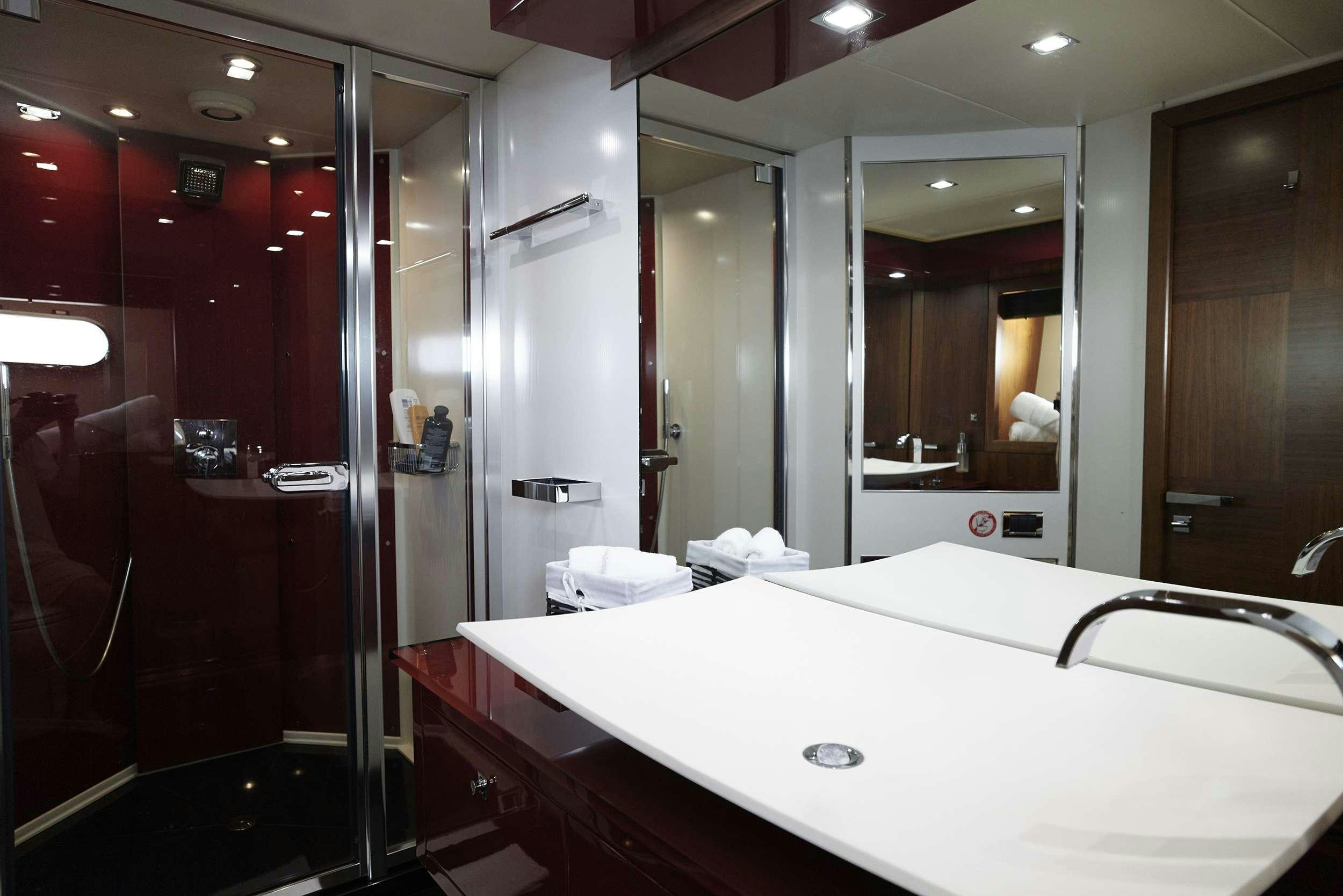 a bathroom with a large mirror aboard UM7 Yacht for Charter