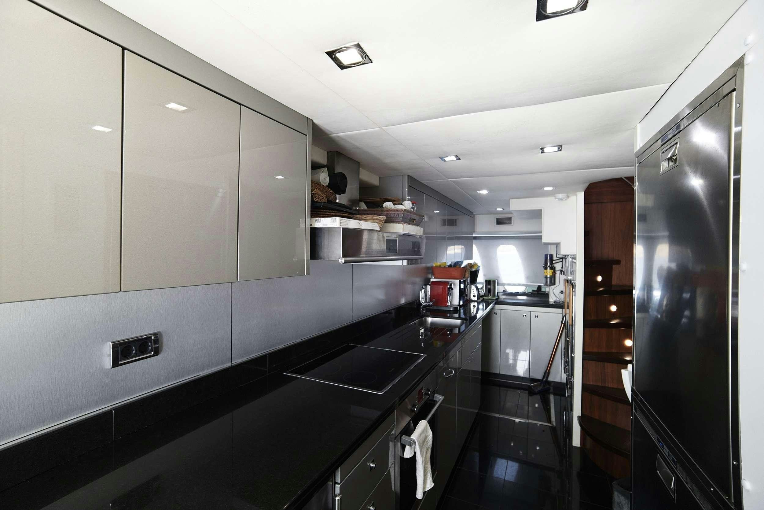 a kitchen with a large refrigerator aboard UM7 Yacht for Charter