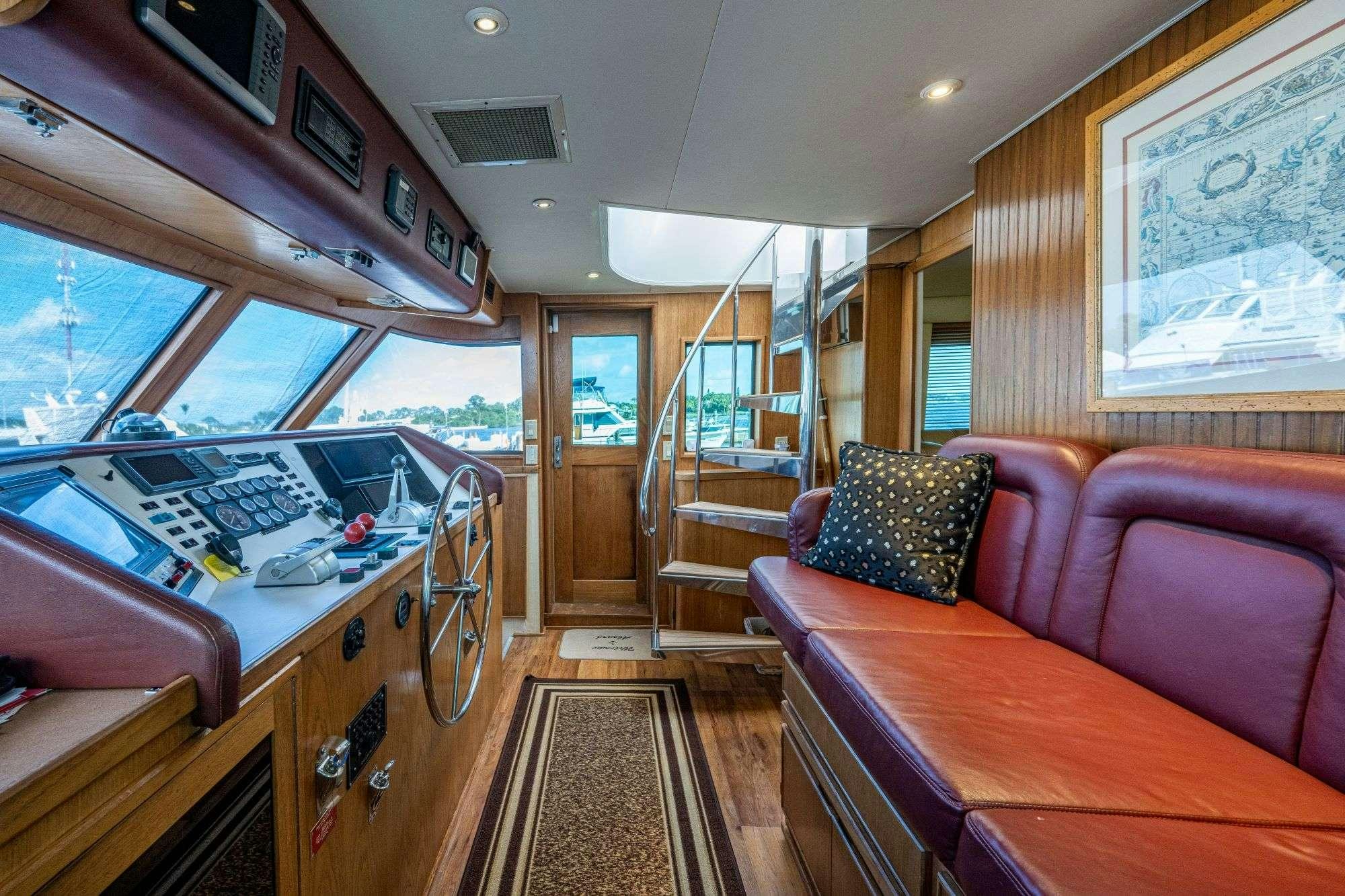 a train car with a table and couches aboard BANDIT Yacht for Charter