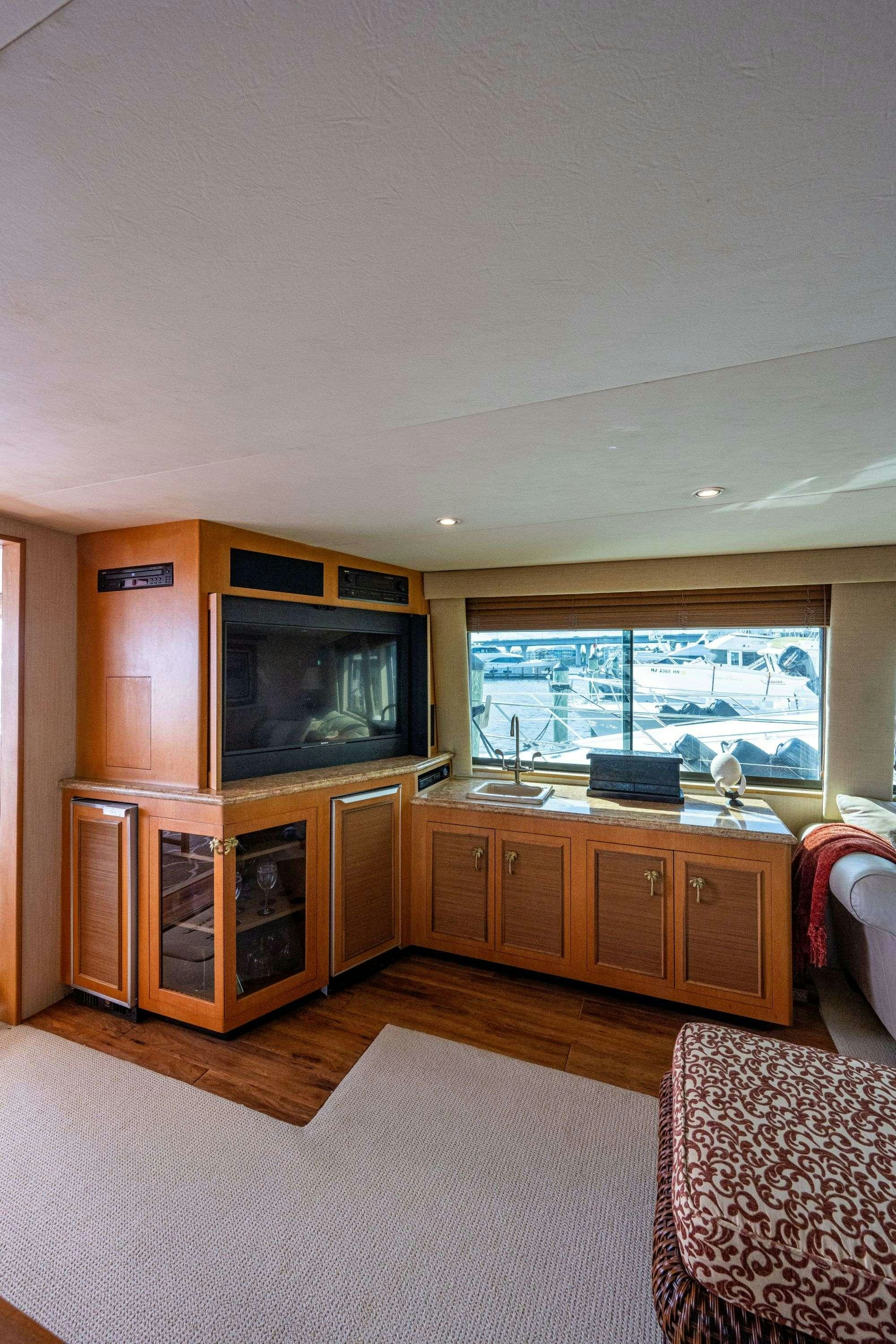 a living room with a tv aboard BANDIT Yacht for Charter