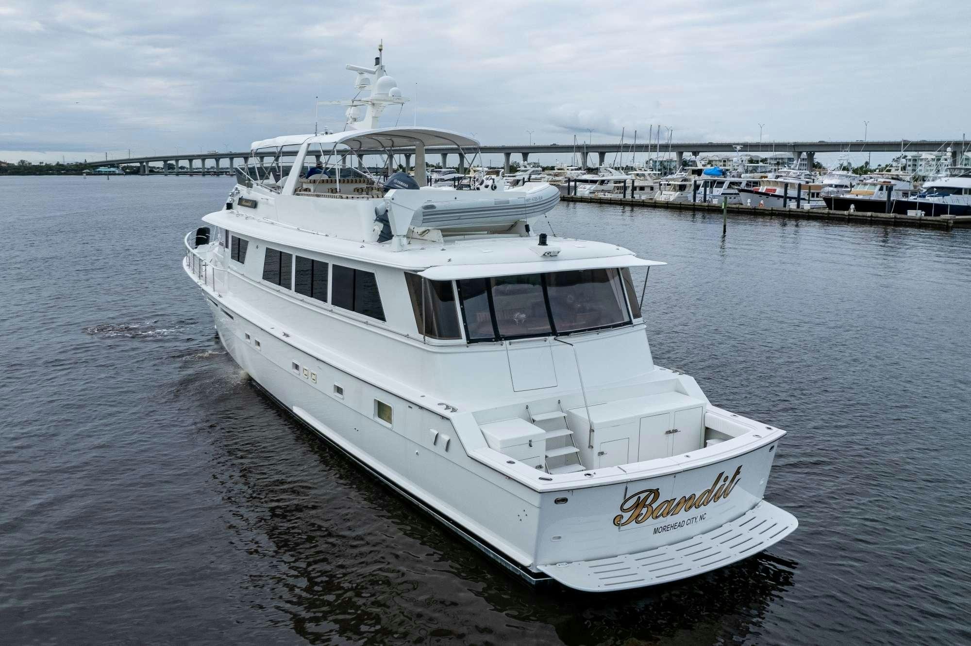 a white boat in a body of water aboard BANDIT Yacht for Charter