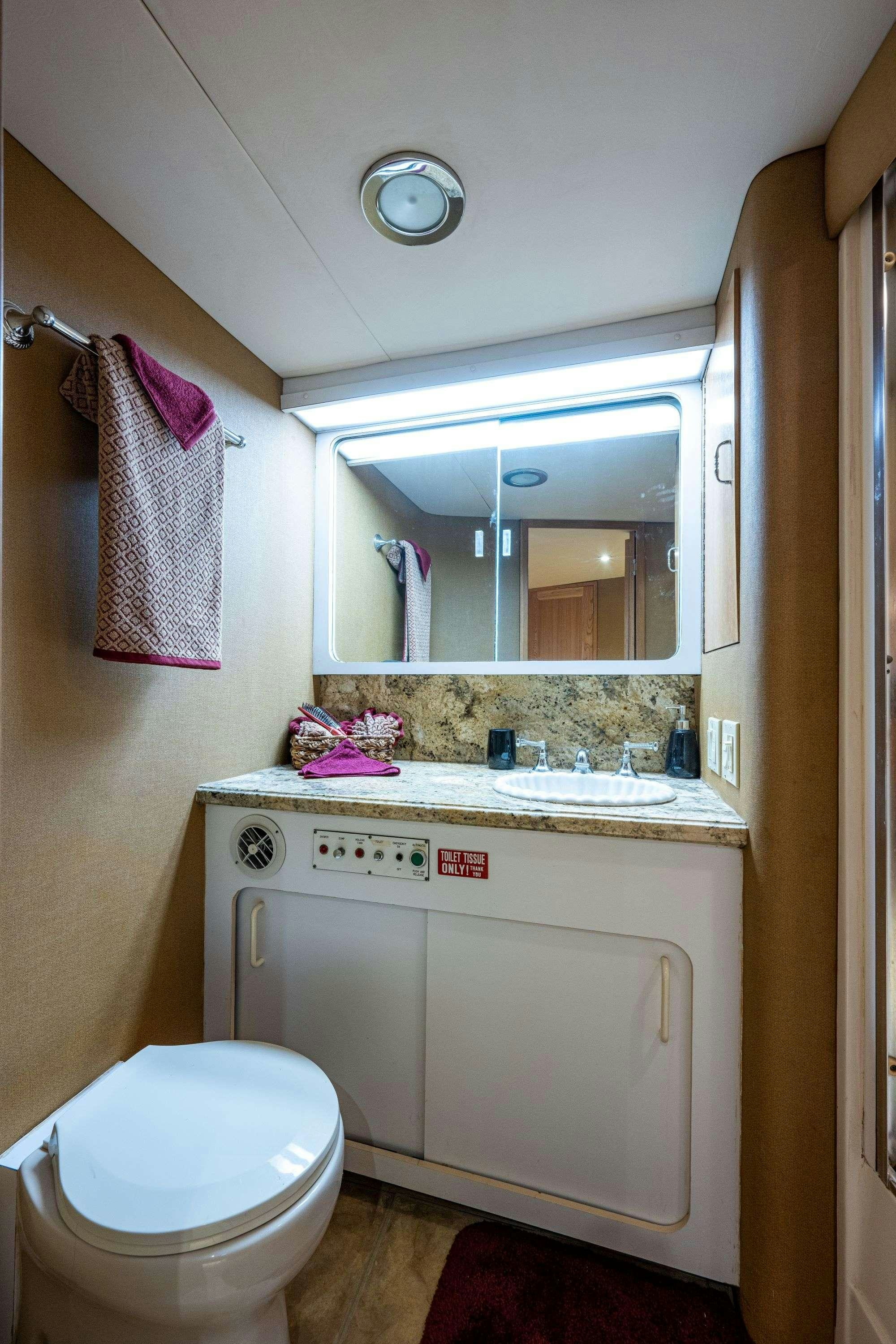 a bathroom with a sink and a mirror aboard BANDIT Yacht for Charter