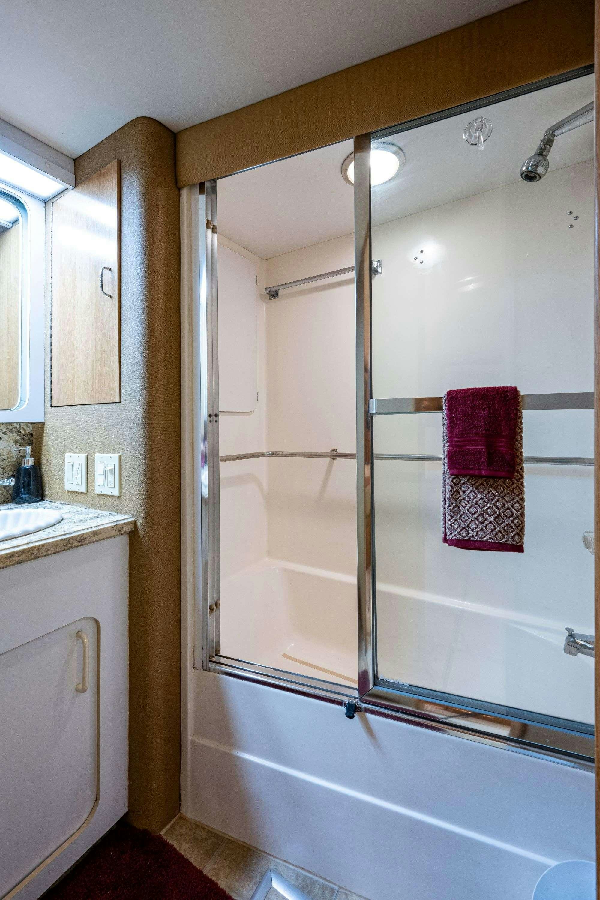 a bathroom with a glass shower aboard BANDIT Yacht for Charter