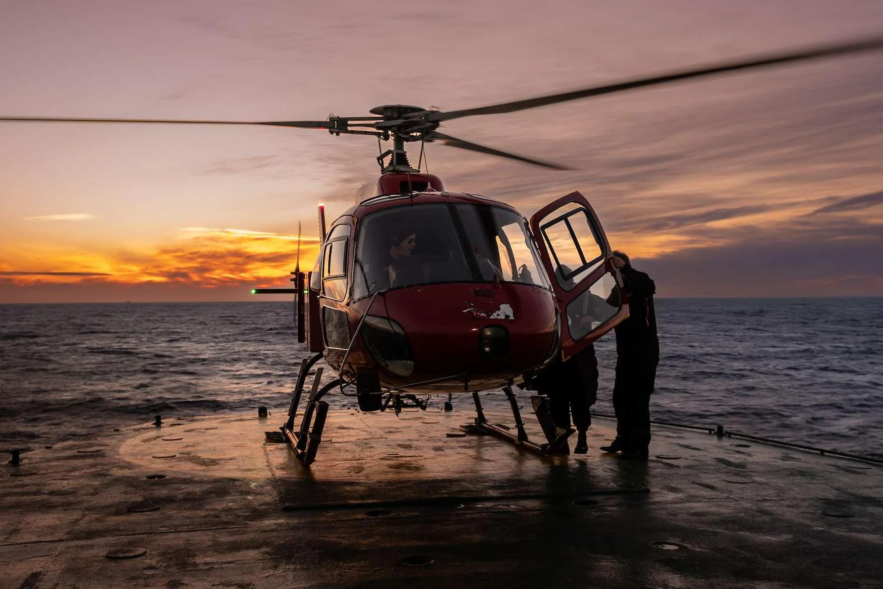 a helicopter on a beach aboard ARGUS Yacht for Charter