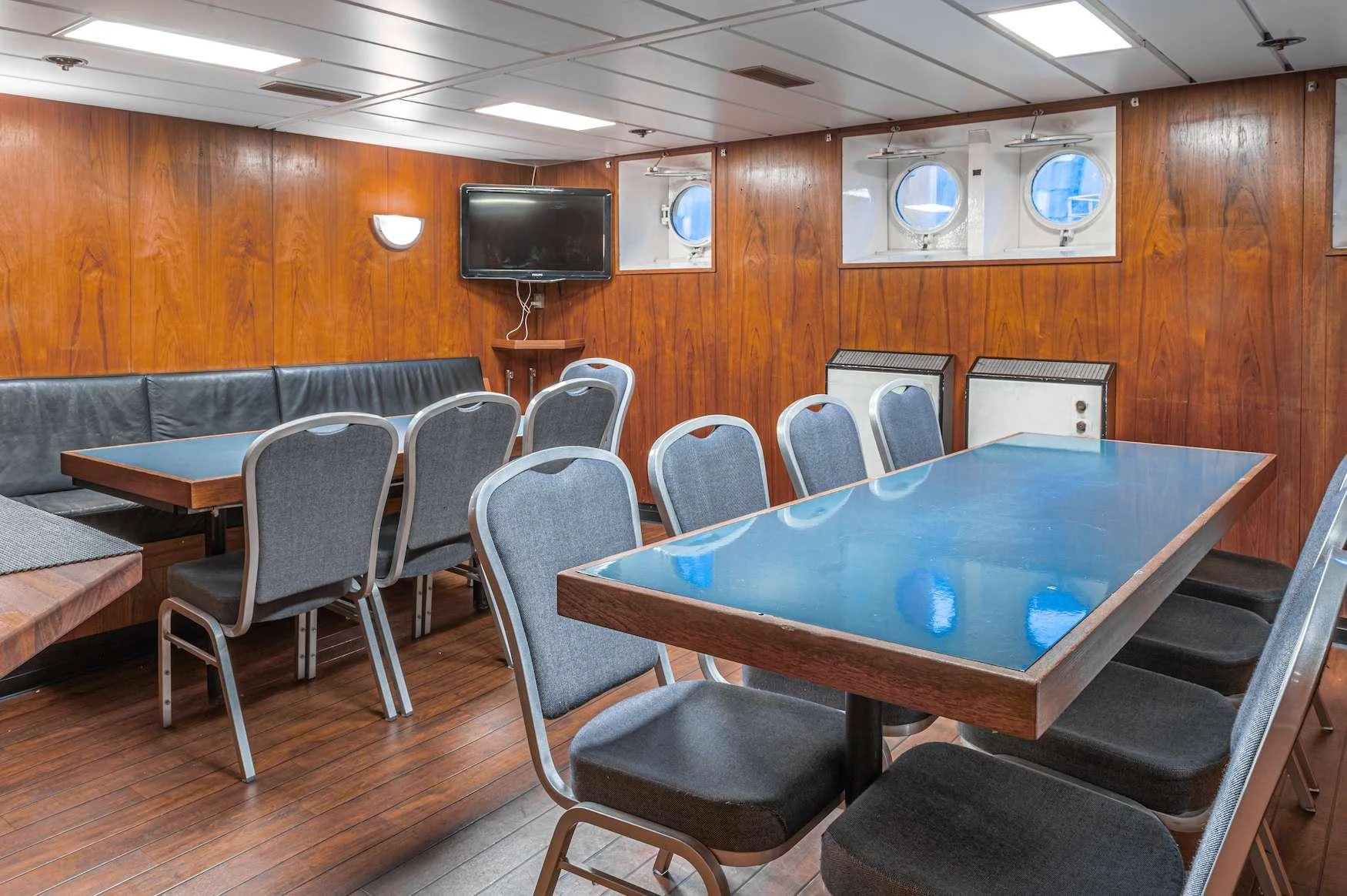 a room with a table and chairs aboard ARGUS Yacht for Charter