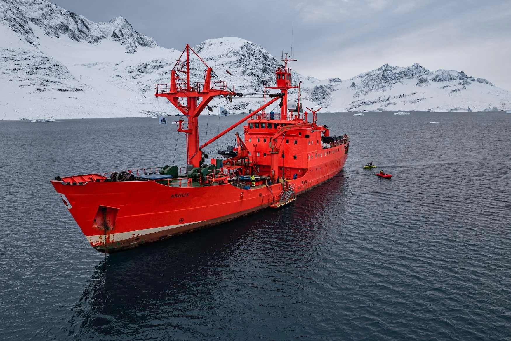 a red boat in the water aboard ARGUS Yacht for Charter