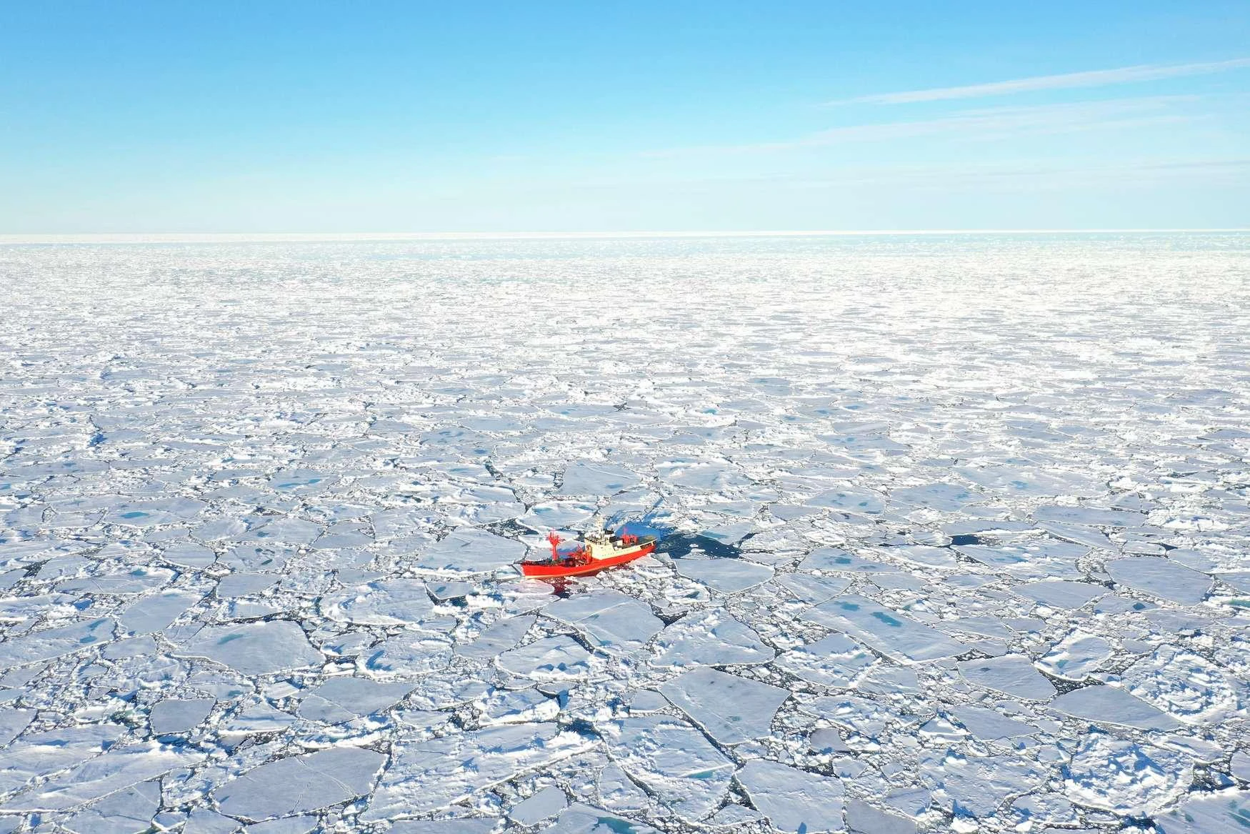 a red boat in a snowy landscape aboard ARGUS Yacht for Charter