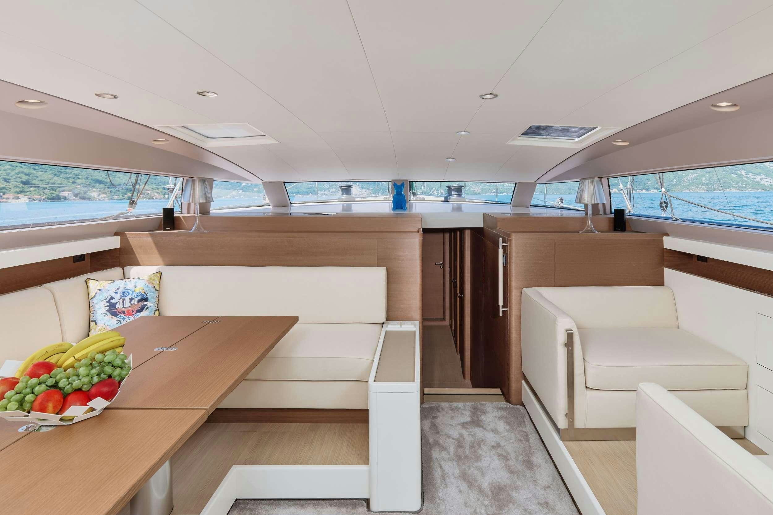 a room with a table and chairs aboard GRATEFUL Yacht for Charter