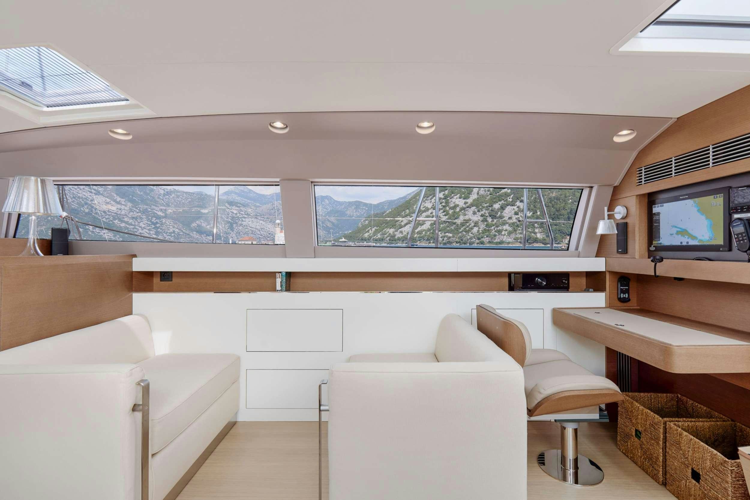 a living room with a large window aboard GRATEFUL Yacht for Charter