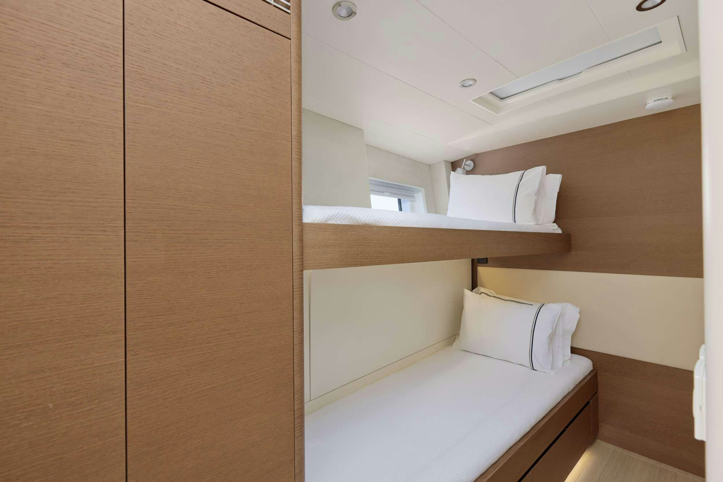 a room with a bed and a closet aboard GRATEFUL Yacht for Charter