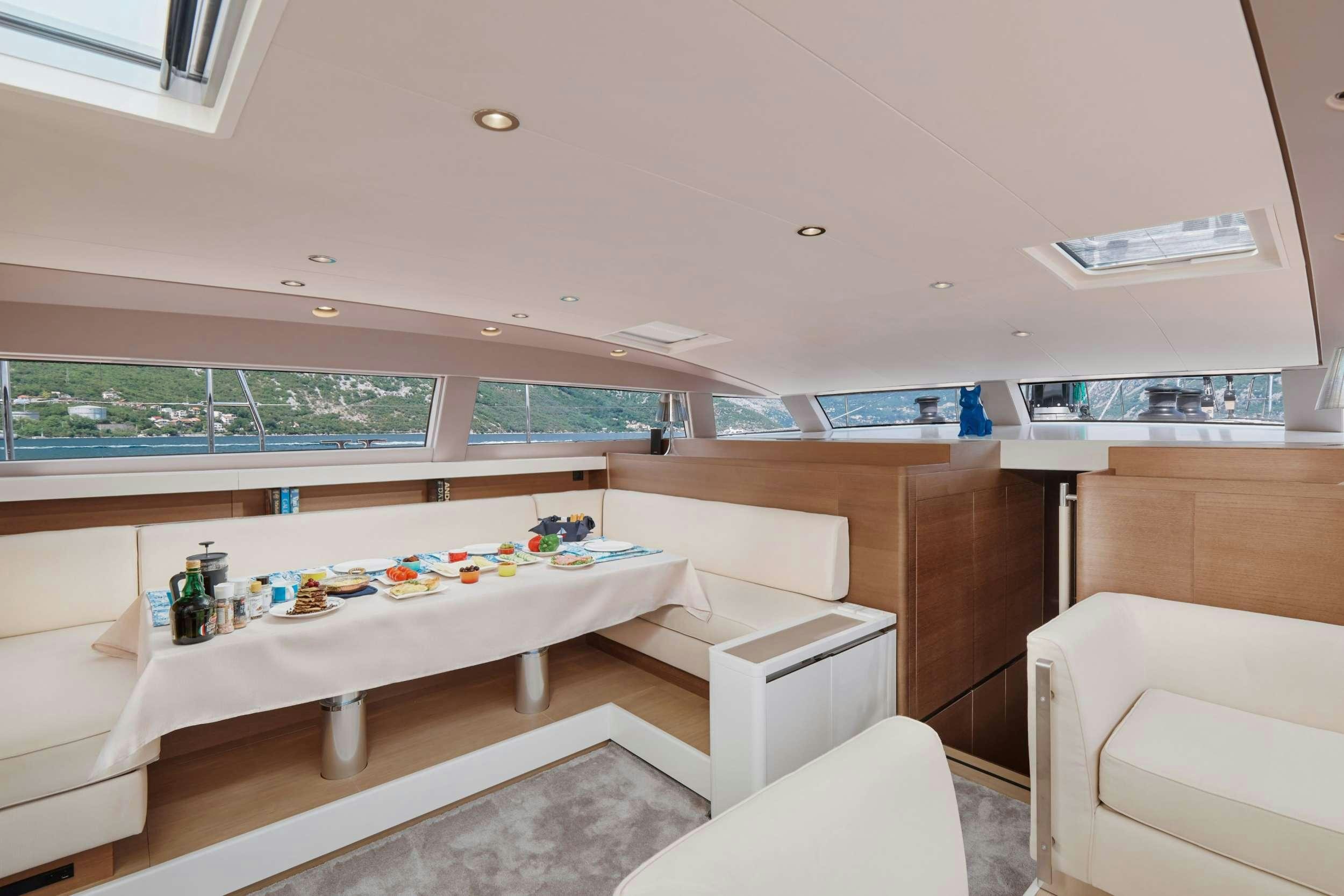 a room with a table and chairs aboard GRATEFUL Yacht for Charter