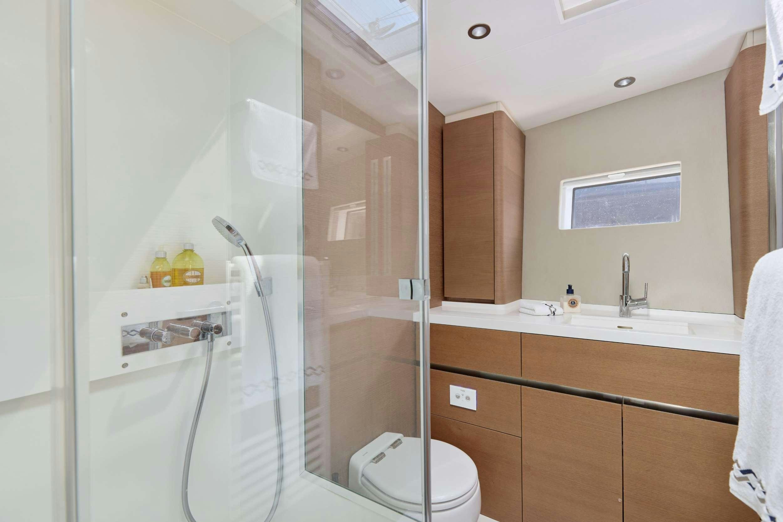 a bathroom with a glass shower aboard GRATEFUL Yacht for Charter