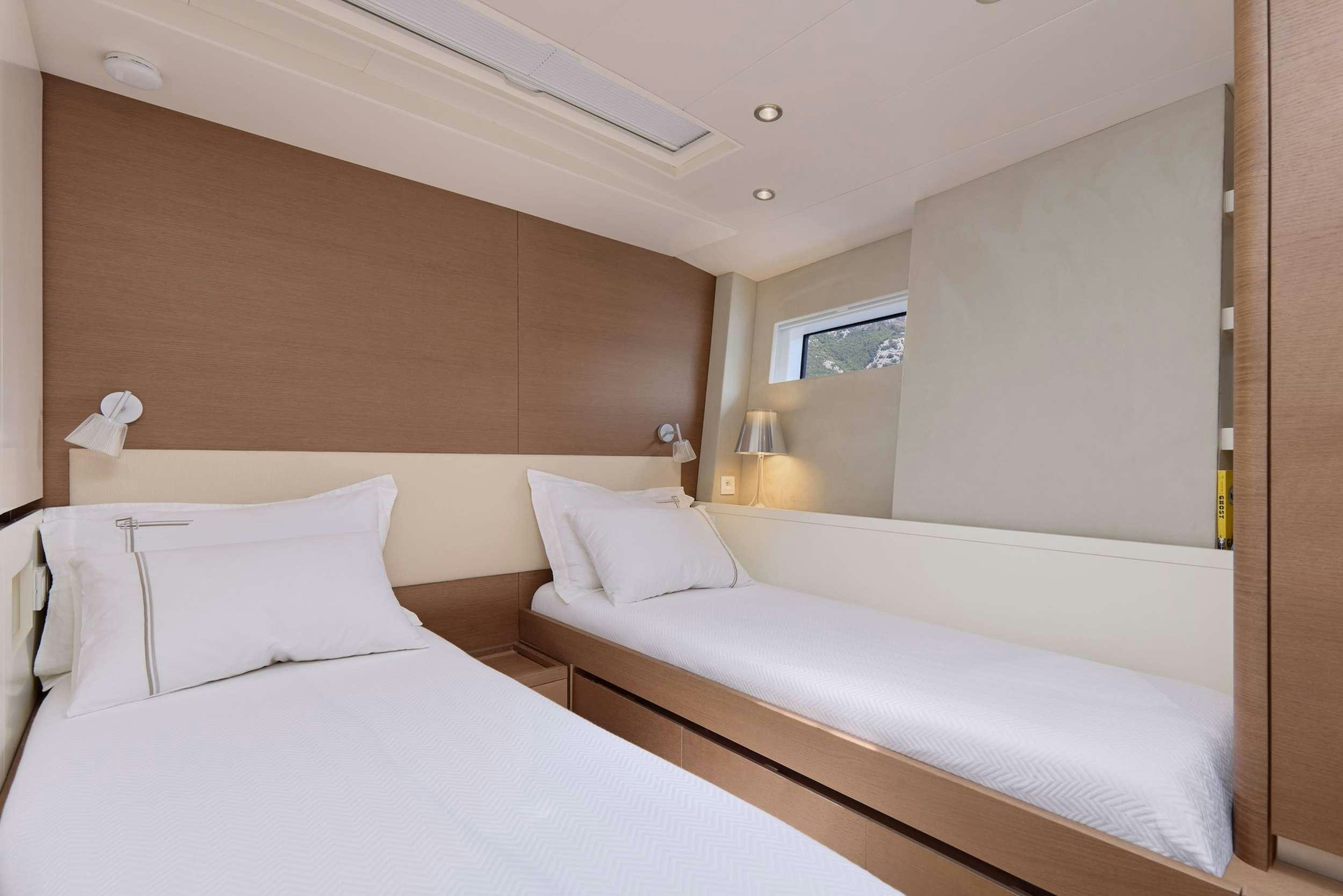 a room with two beds aboard GRATEFUL Yacht for Charter