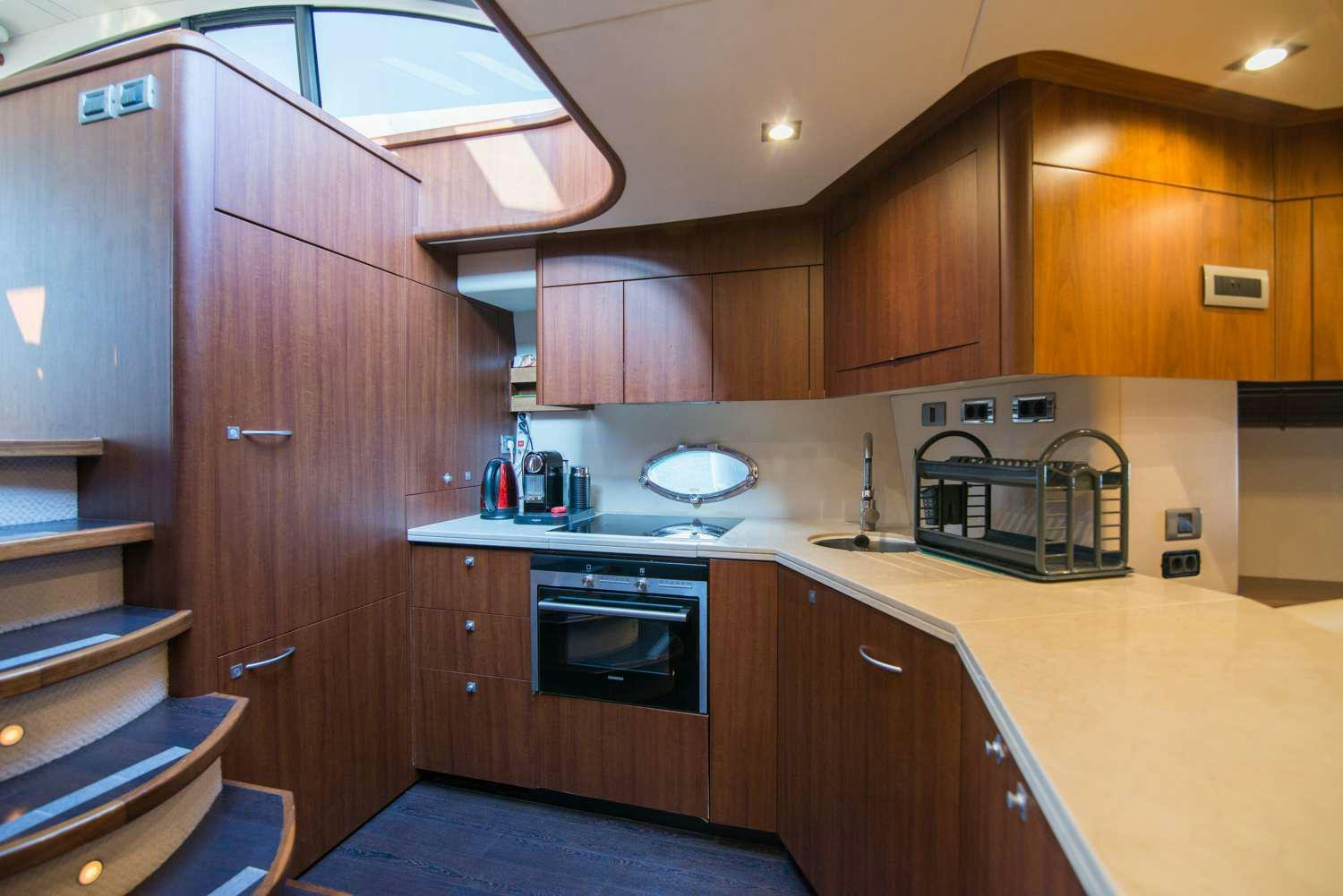 a kitchen with wooden cabinets aboard ELENTARI Yacht for Charter