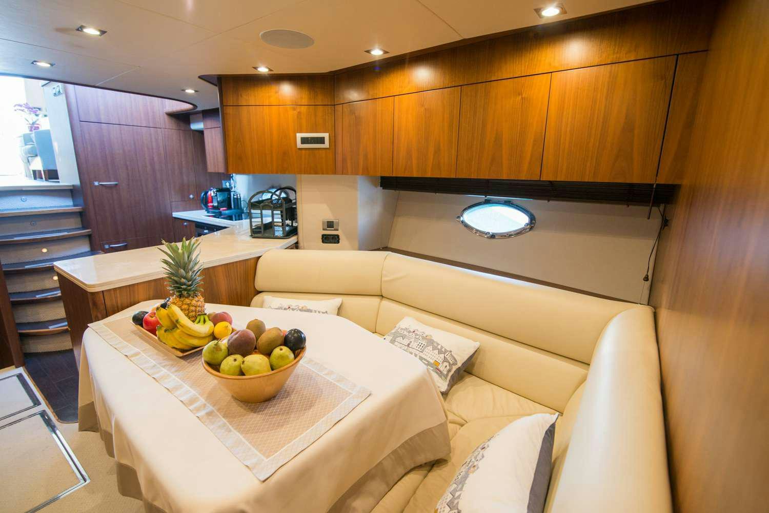 a room with a table and couch aboard ELENTARI Yacht for Charter