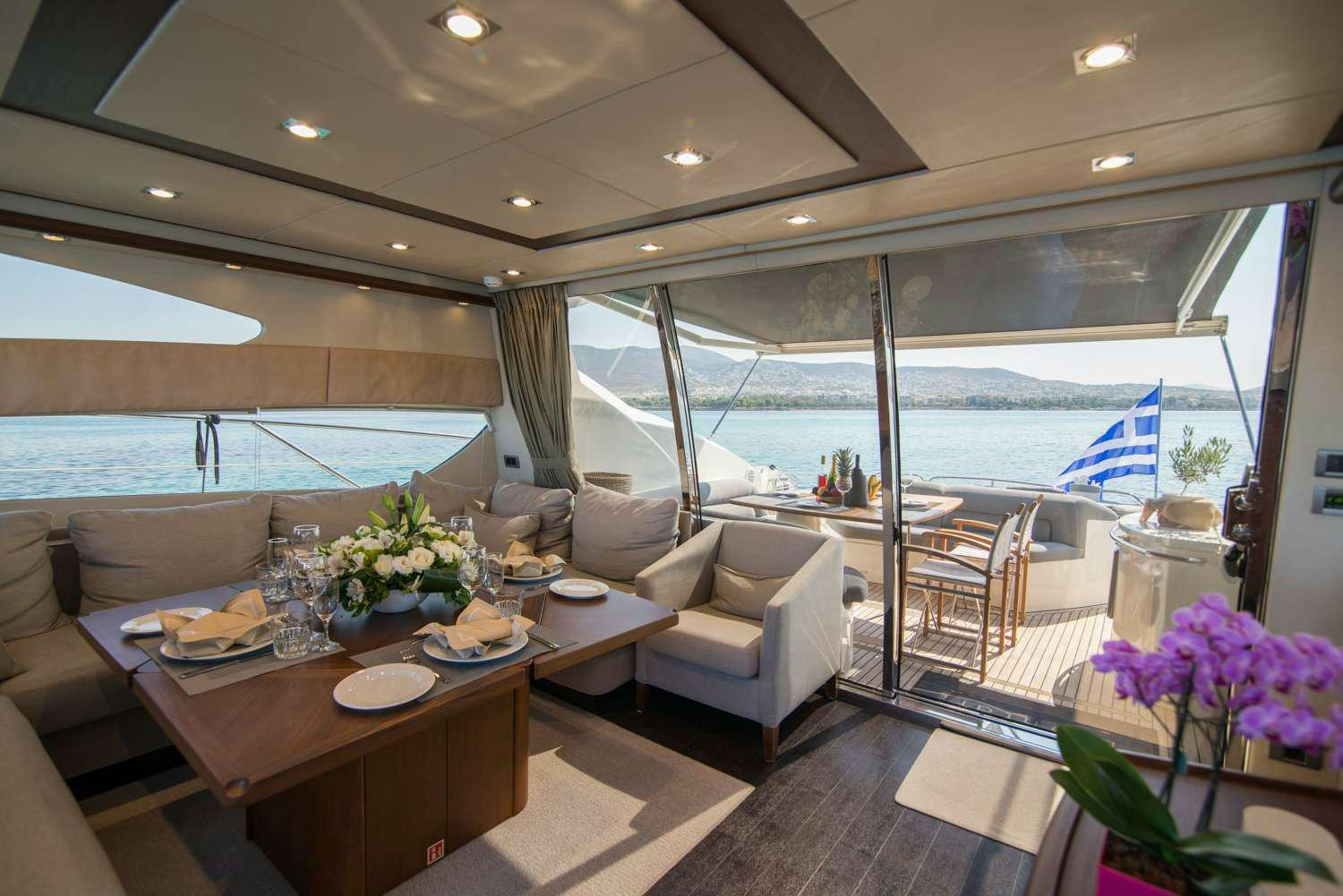a room with a table chairs and a view of the ocean aboard ELENTARI Yacht for Charter