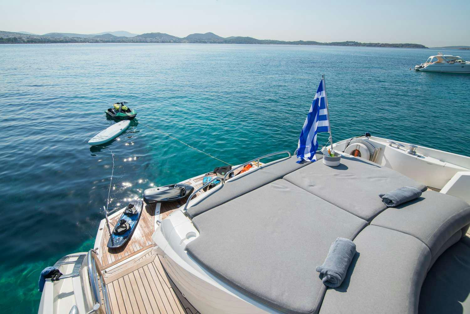 a boat with a flag on it aboard ELENTARI Yacht for Charter