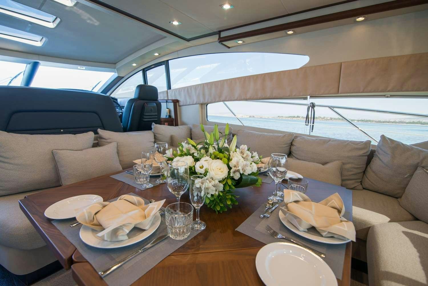 a table with plates and glasses on it aboard ELENTARI Yacht for Charter