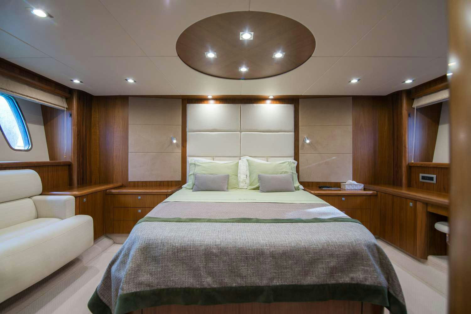 a room with a bed and a couch aboard ELENTARI Yacht for Charter