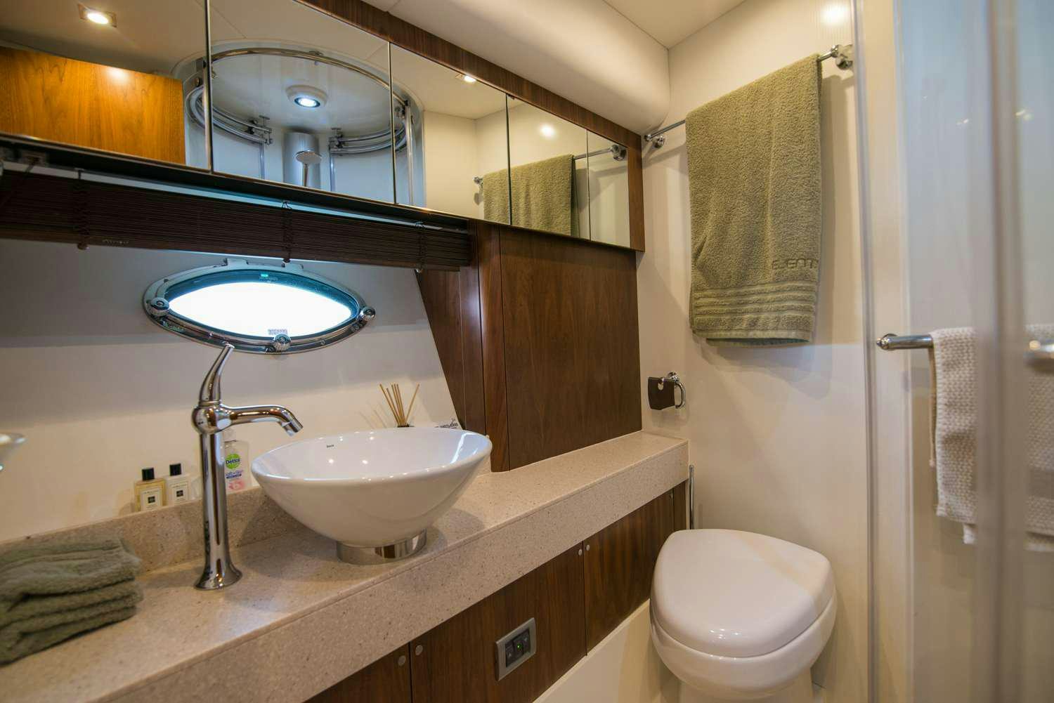 a bathroom with a large mirror aboard ELENTARI Yacht for Charter