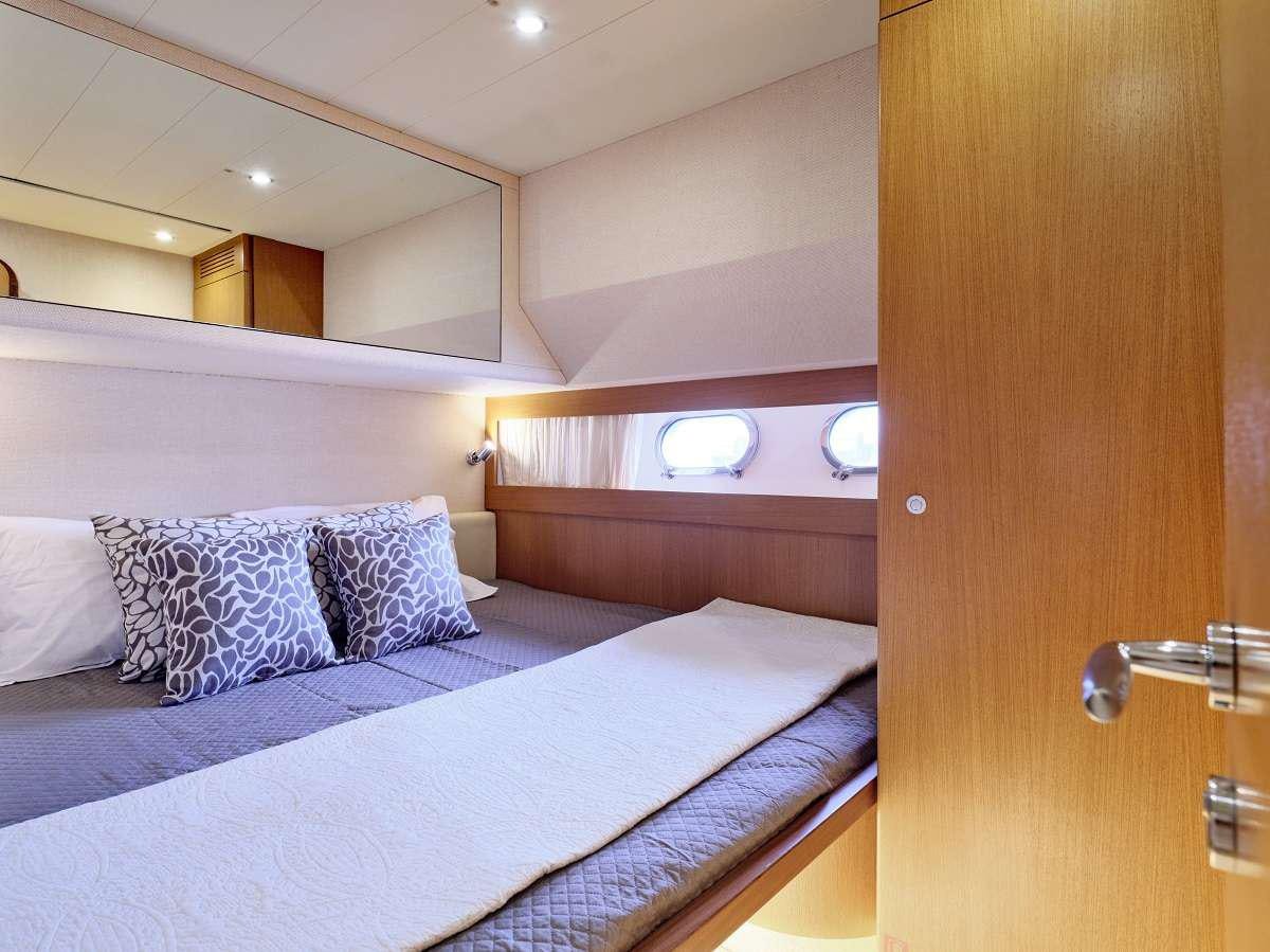 a bed with a white bed spread aboard FLOW Yacht for Charter