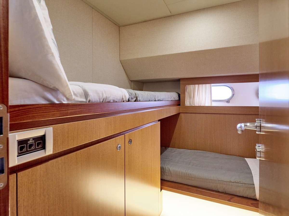 a bed with a phone on it aboard FLOW Yacht for Charter