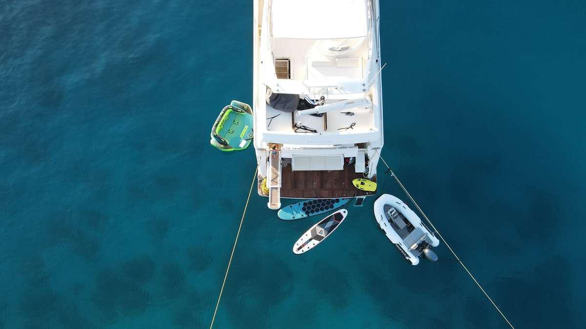 a boat with a motor attached to it aboard FLOW Yacht for Charter