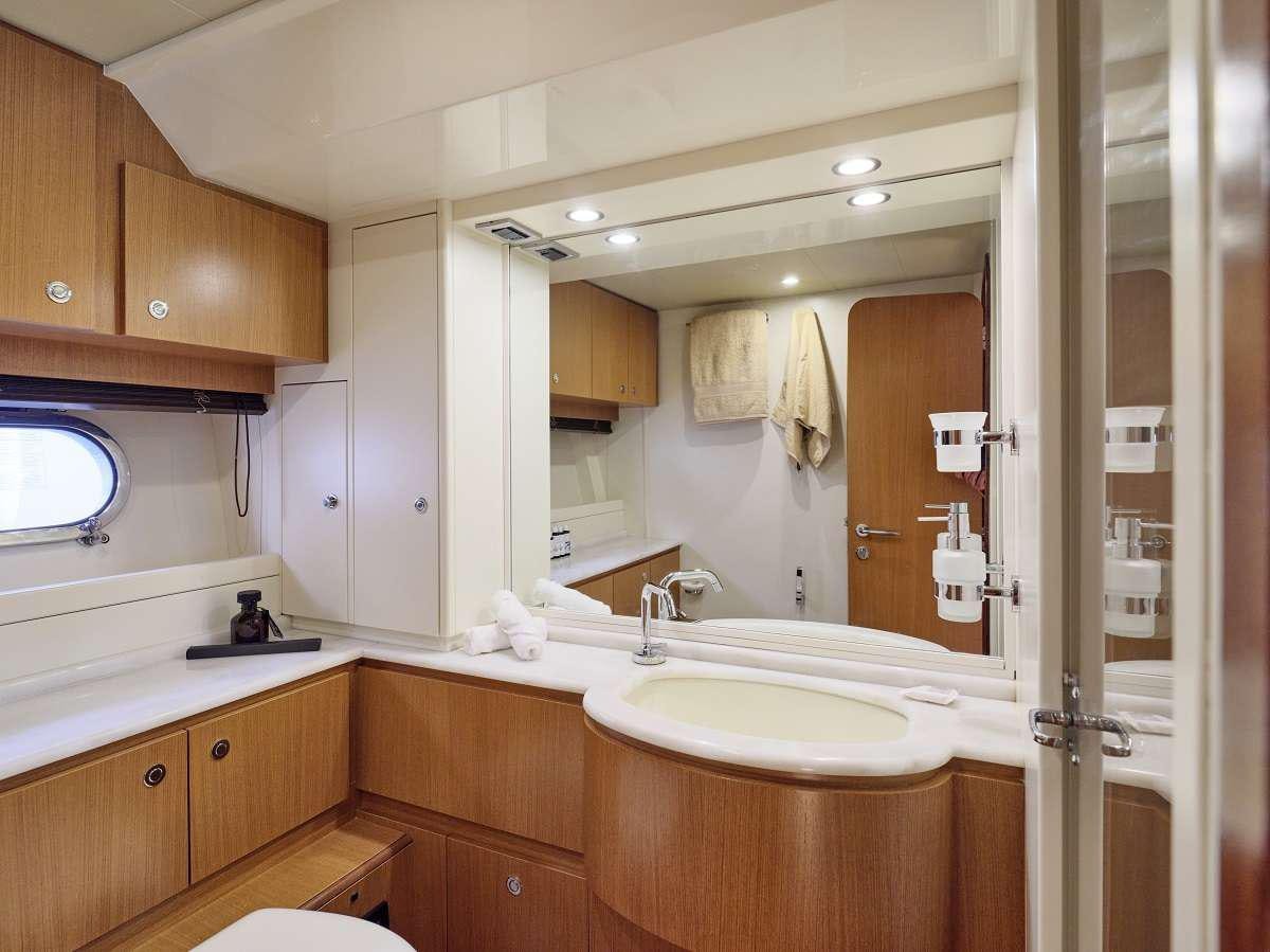 a bathroom with a large mirror aboard FLOW Yacht for Charter