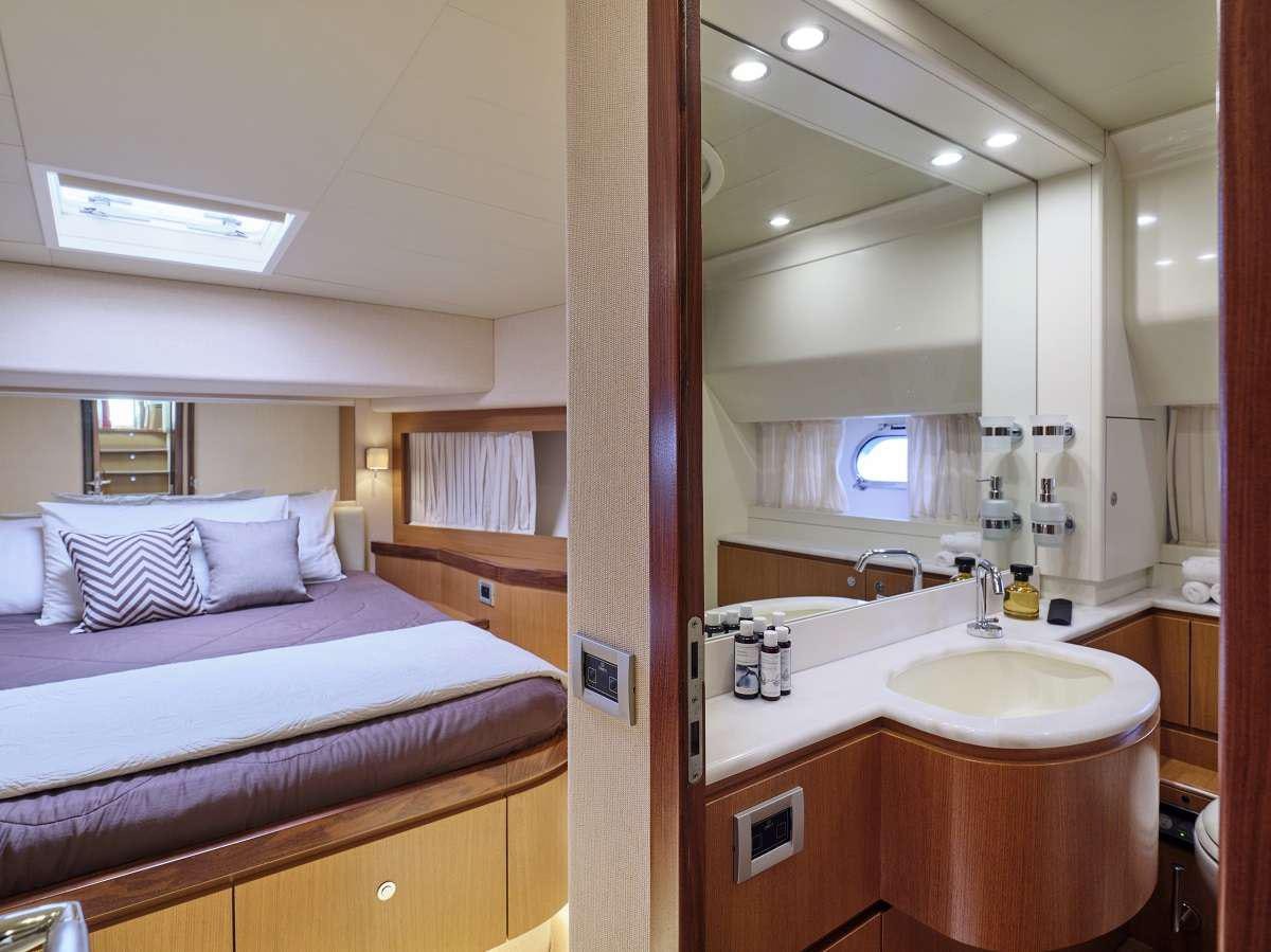 a bathroom with a bed sink and a mirror aboard FLOW Yacht for Charter