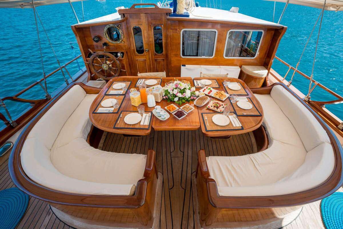 a table with plates and food on it aboard P Yacht for Charter