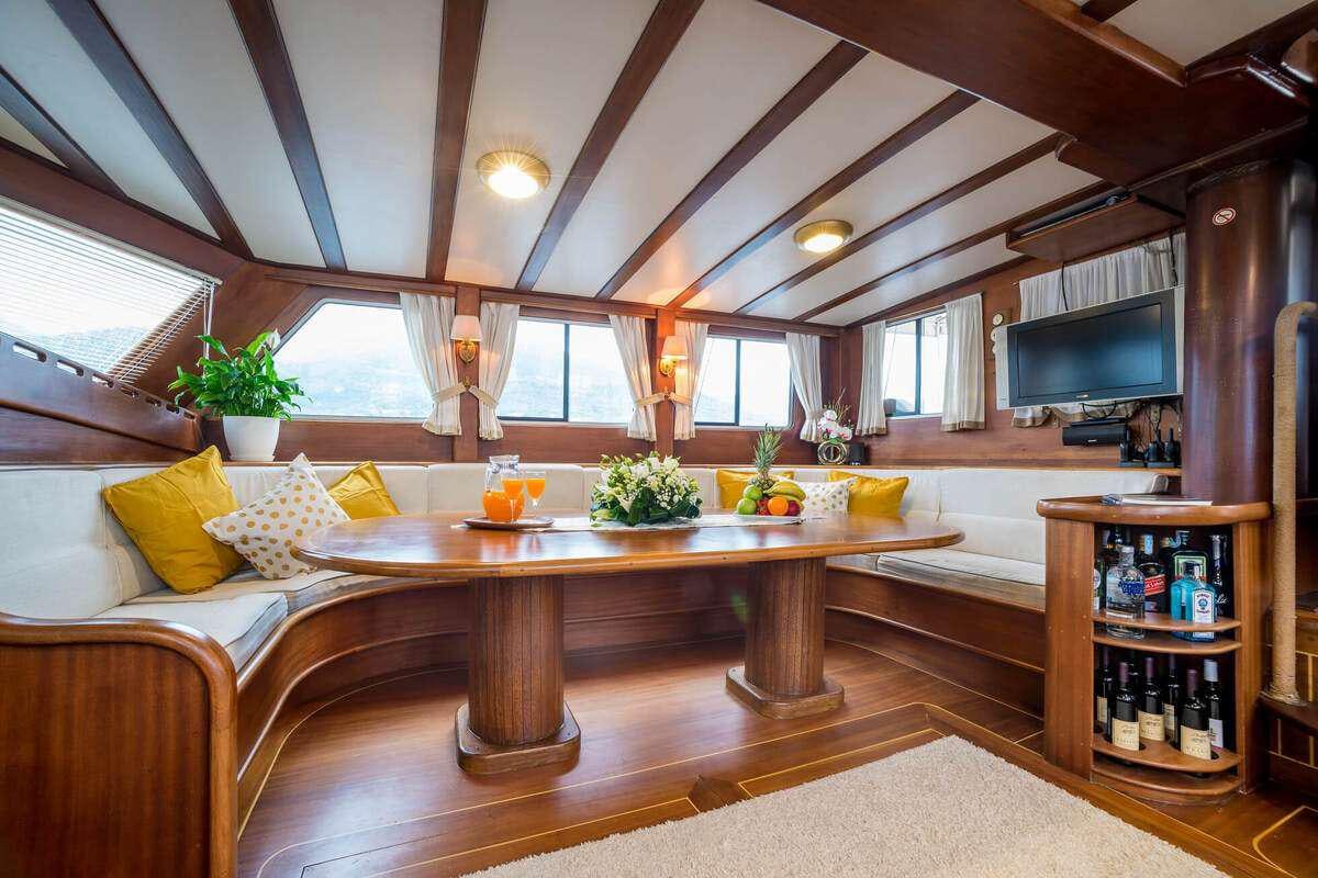 a living room with a table and couches aboard P Yacht for Charter