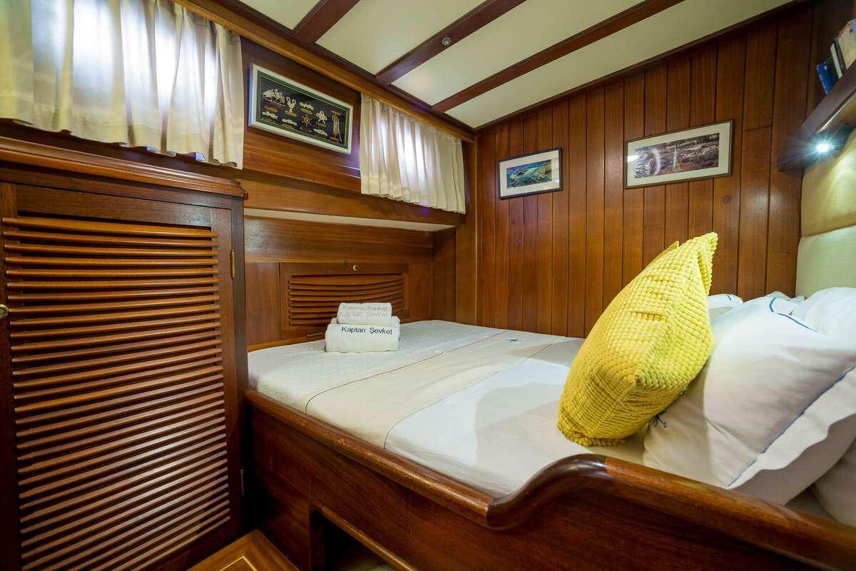 a bed with a wood headboard aboard P Yacht for Charter