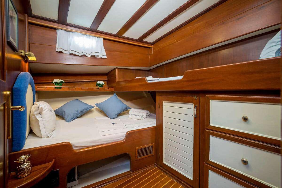 a bed with a wooden frame aboard P Yacht for Charter