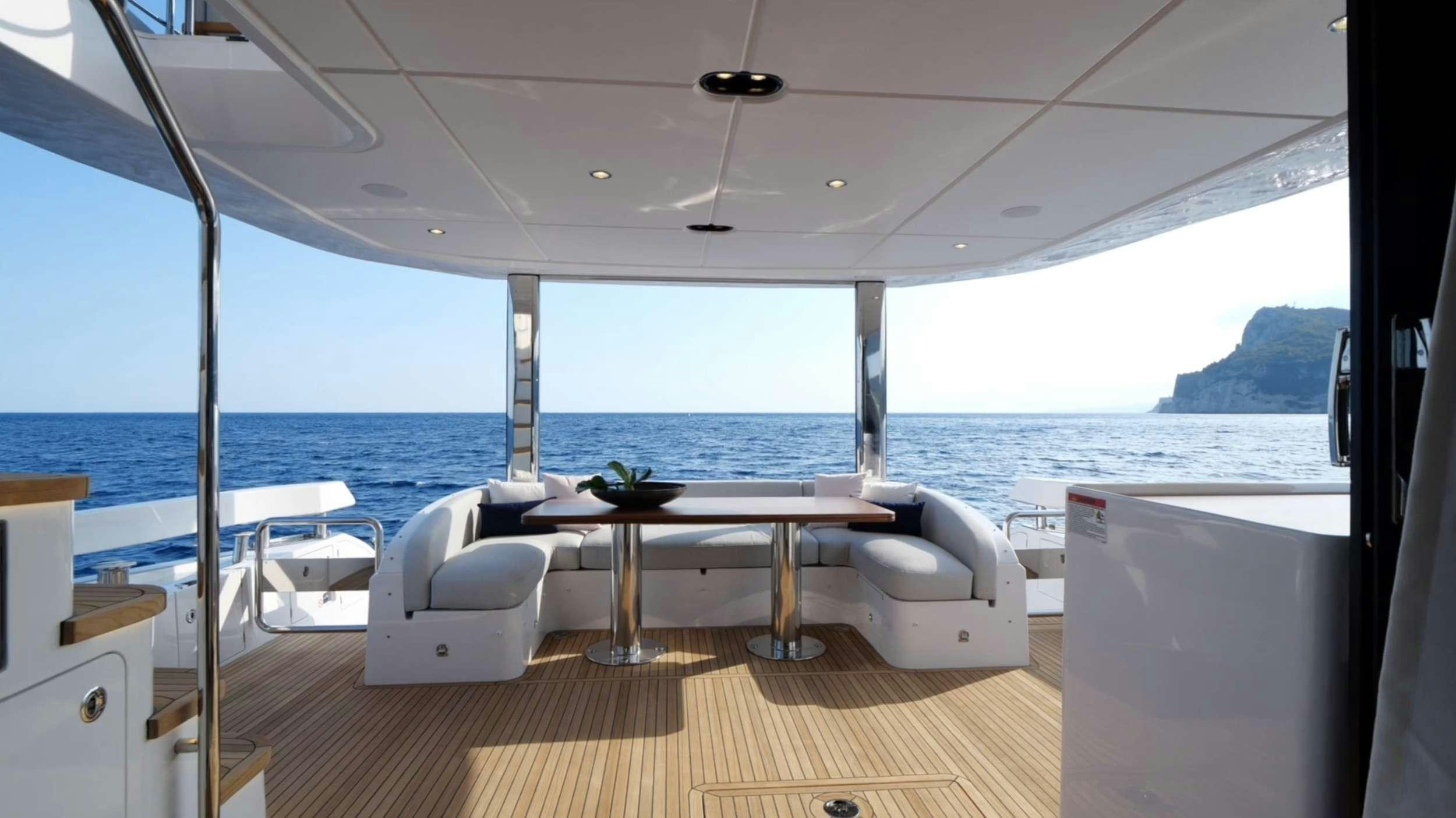 a room with a table and chairs aboard PARADISE PEARL Yacht for Charter