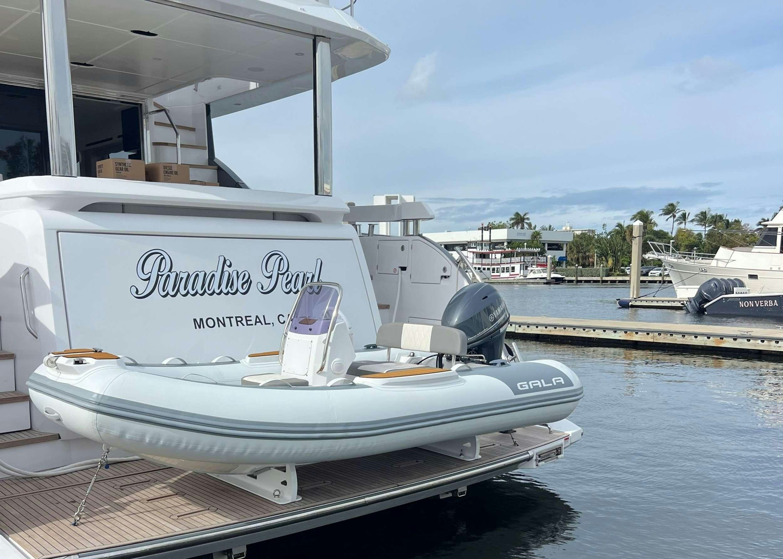a boat docked at a pier aboard PARADISE PEARL Yacht for Charter