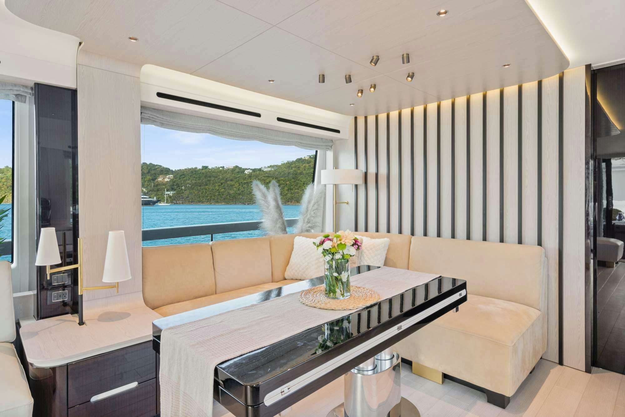 a living room with a large window aboard PARADISE PEARL Yacht for Charter