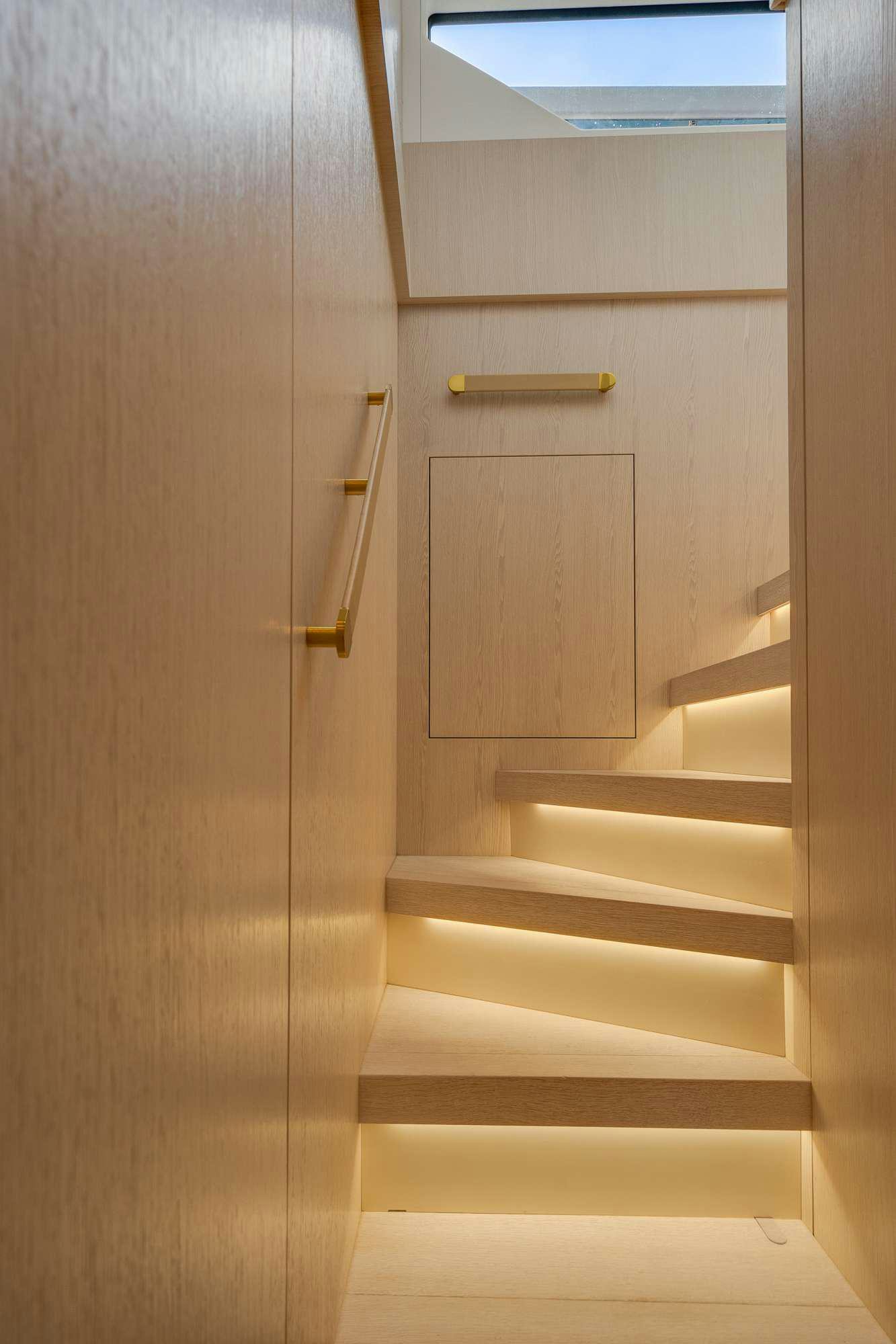 a white door with a wooden handle aboard PARADISE PEARL Yacht for Charter