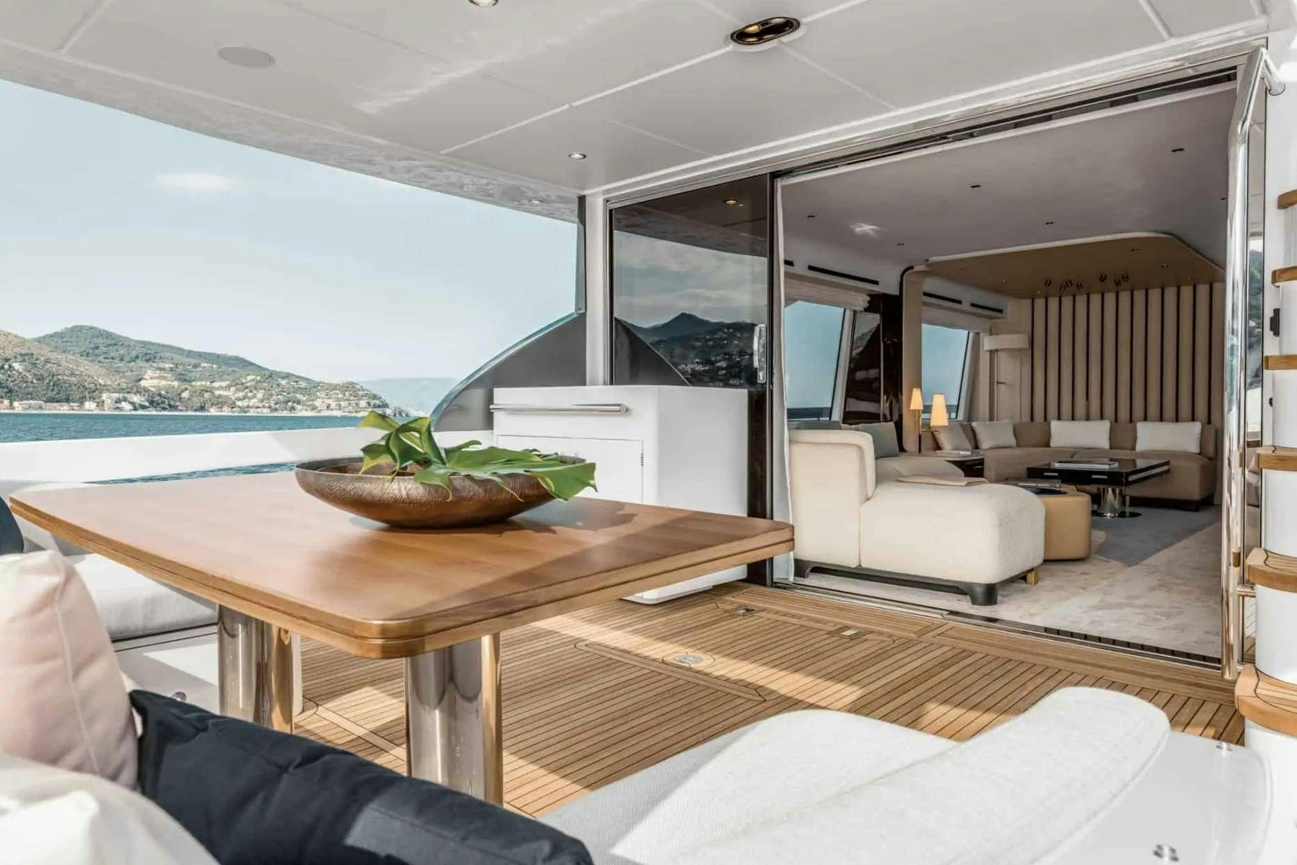 a modern looking living room with a large open window aboard PARADISE PEARL Yacht for Charter